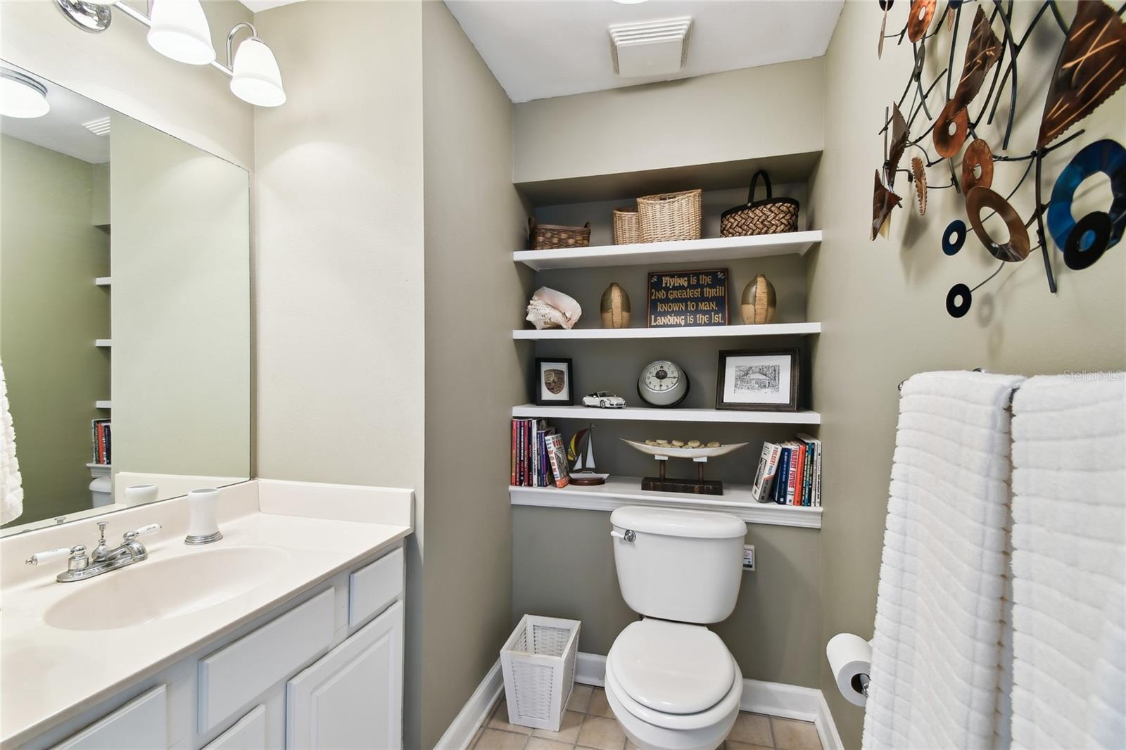 Half bathroom with built in storage.