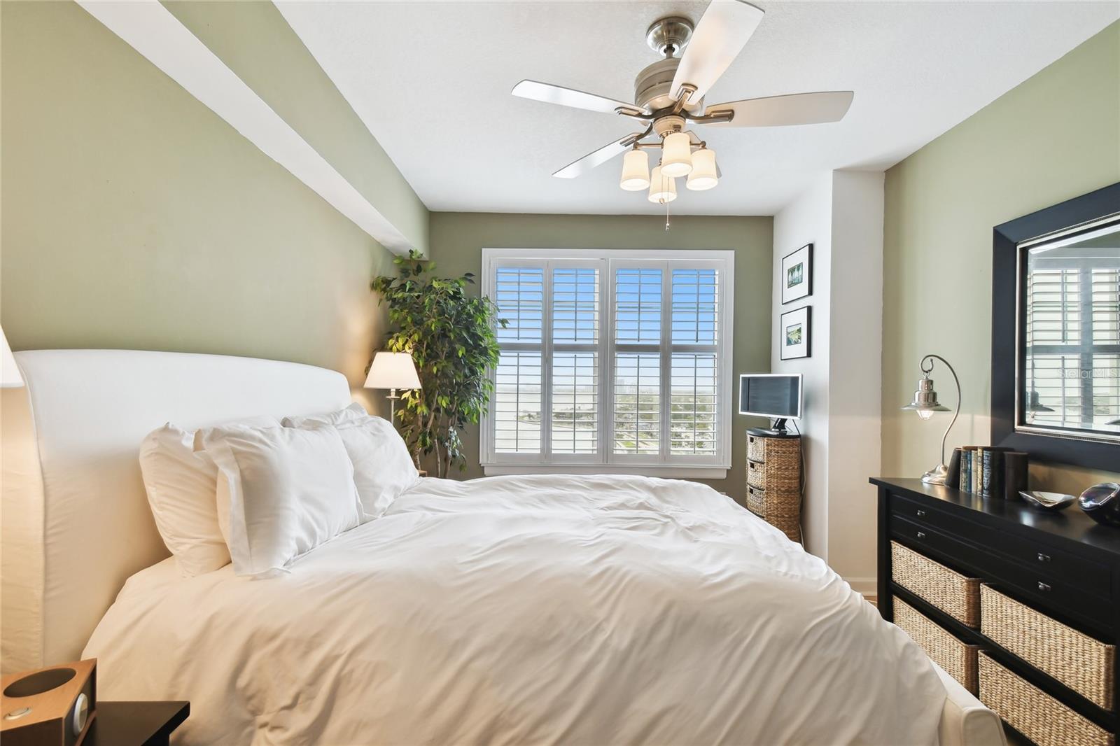 Cozy bedroom with natural light and stunning window views.