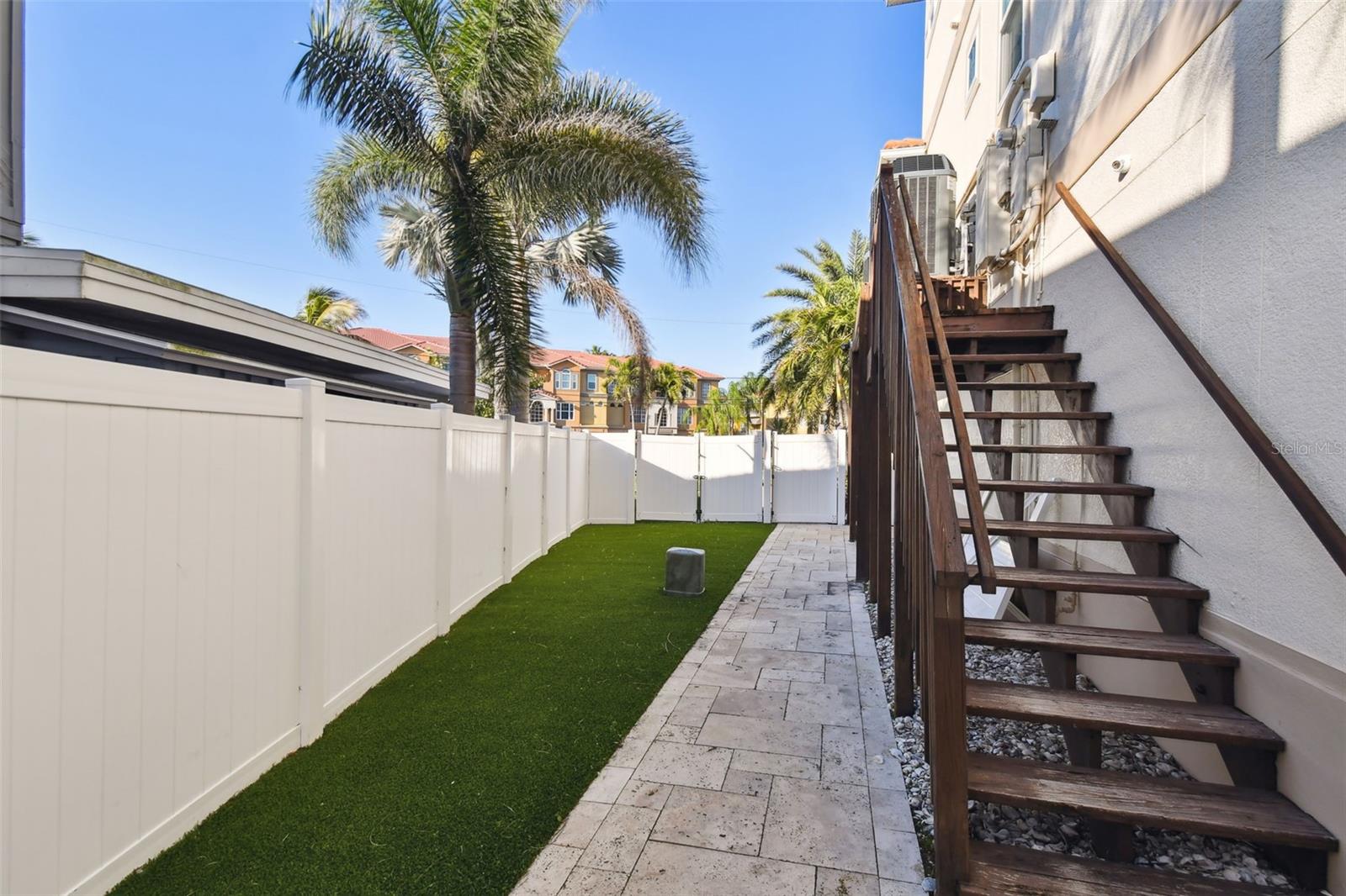 Side yard: Elevated HVACs & Generator