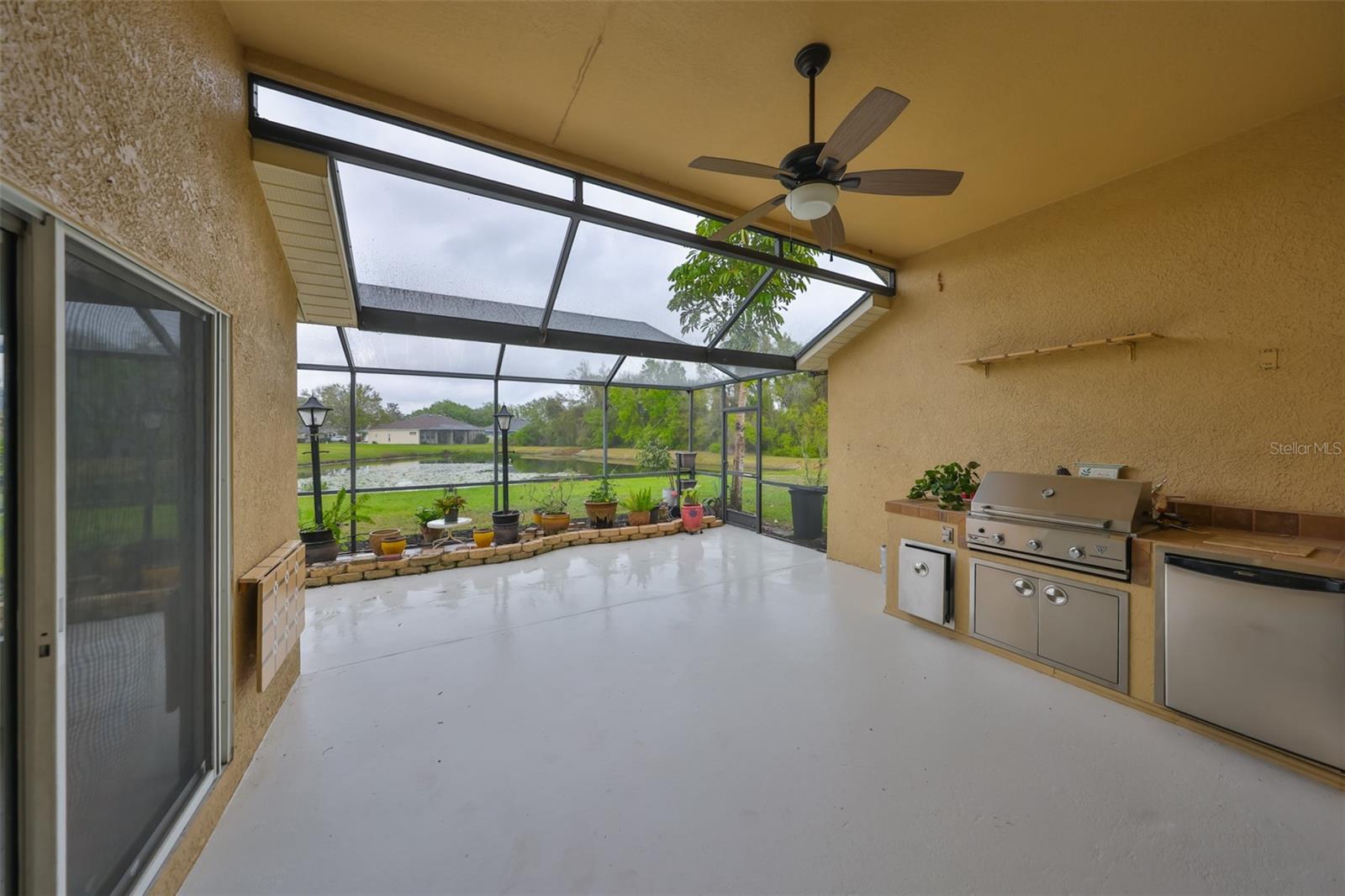 Outdoor kitchen and a ceiling fan to keep you cool