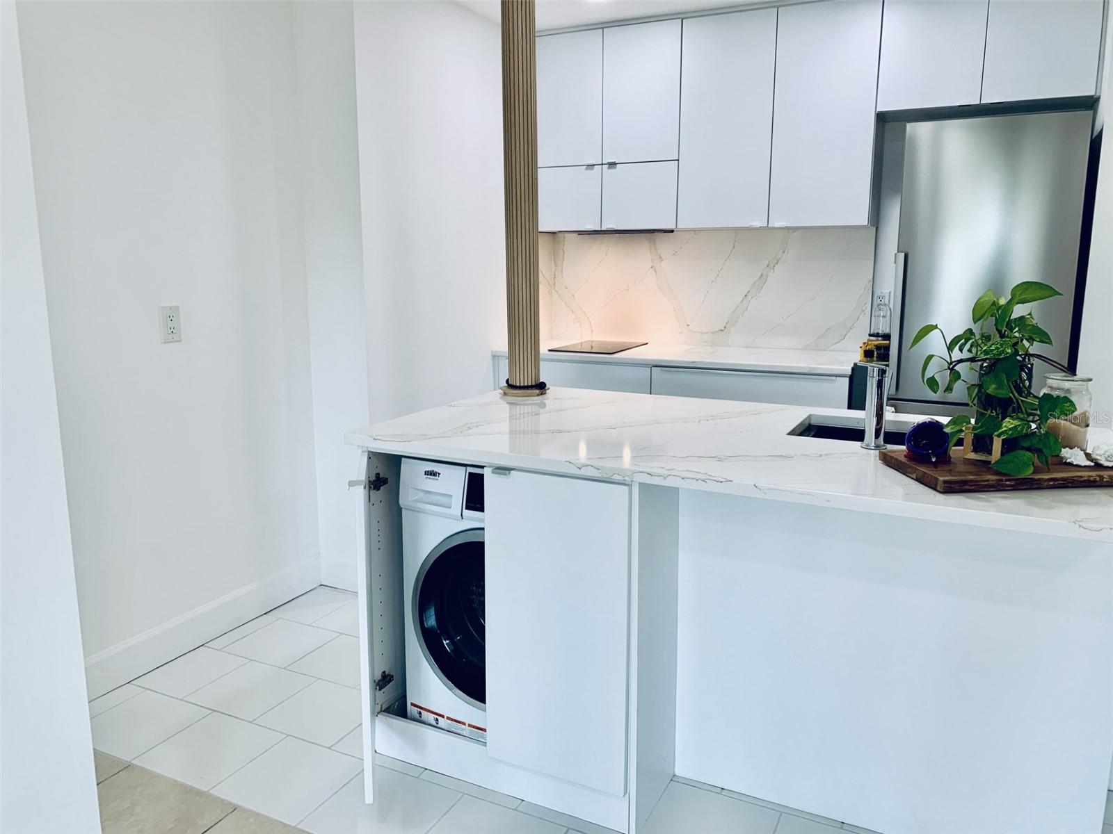 Washer-Dryer combo is in kitchen