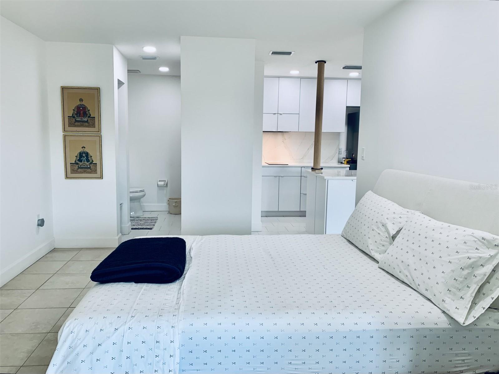 Primary bedroom with bath in distance