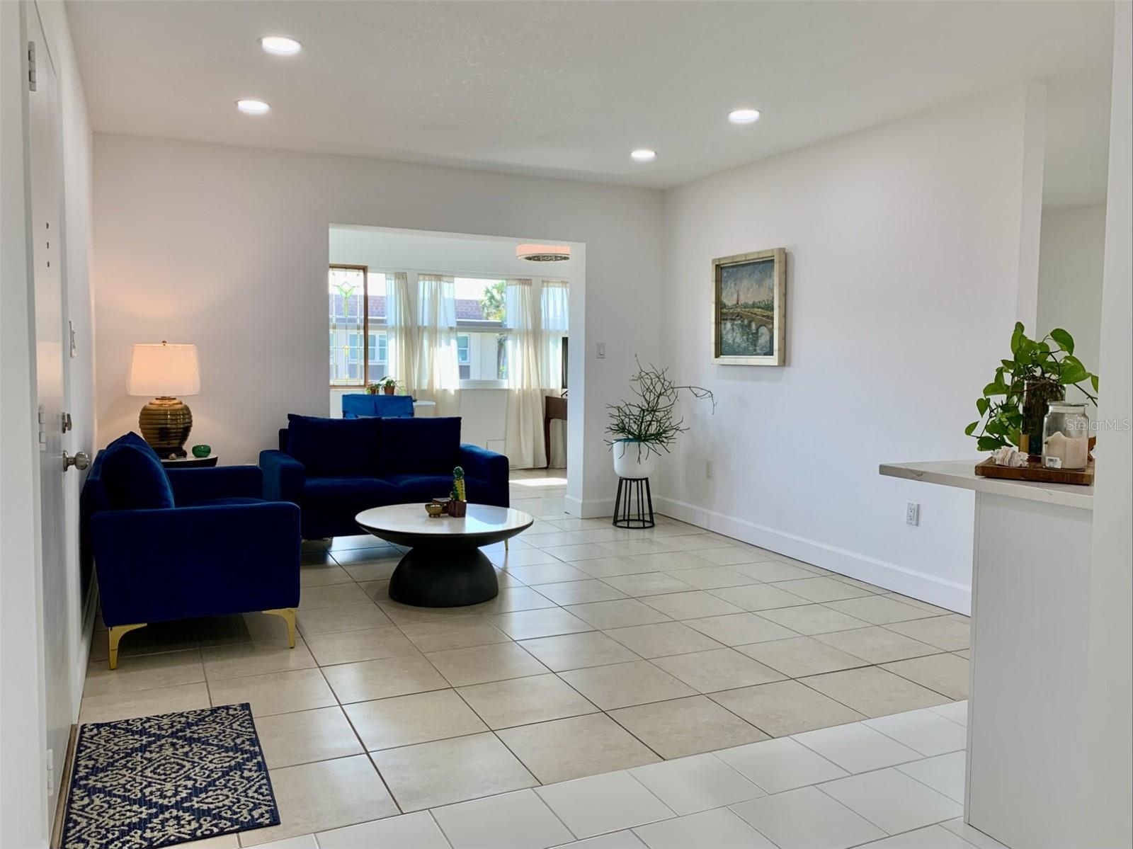 View of living room and sun room in the distance