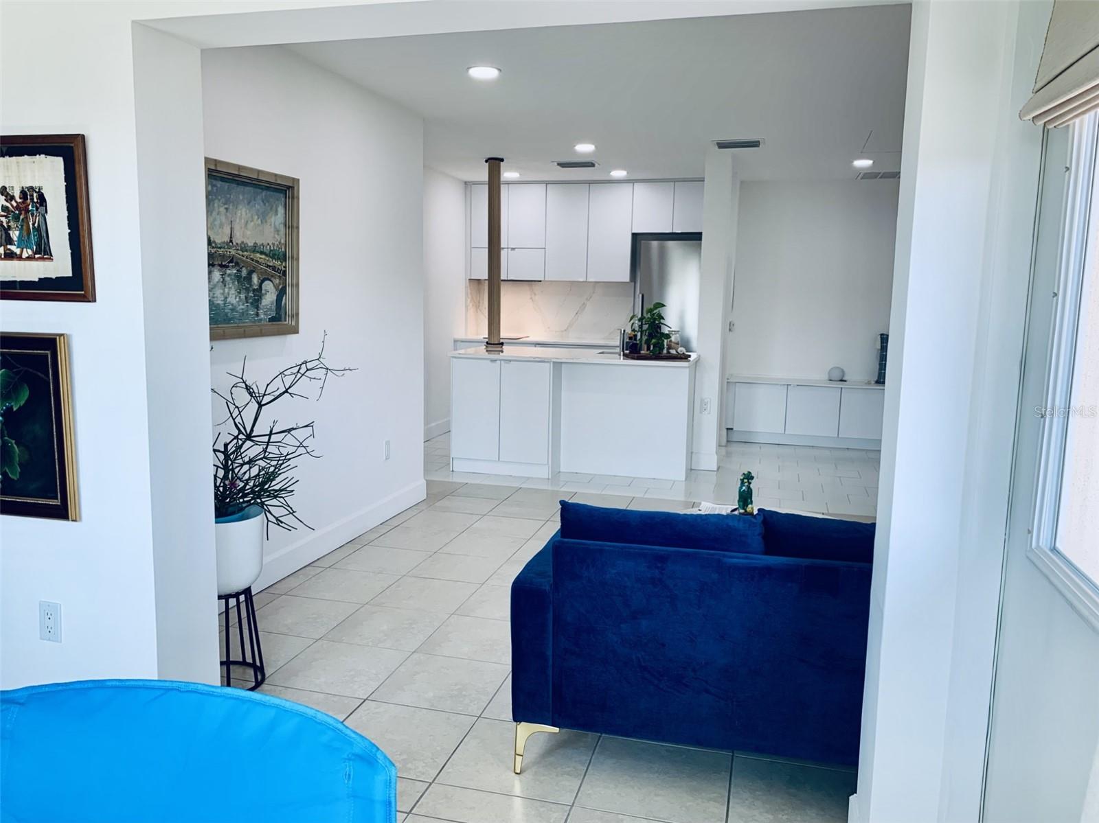 View of living room and kitchen from sunroom