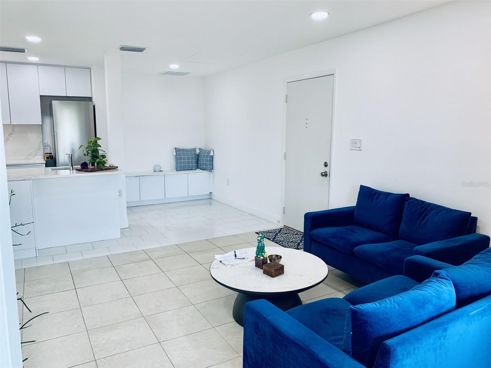 View of living room, kitchen and dining room