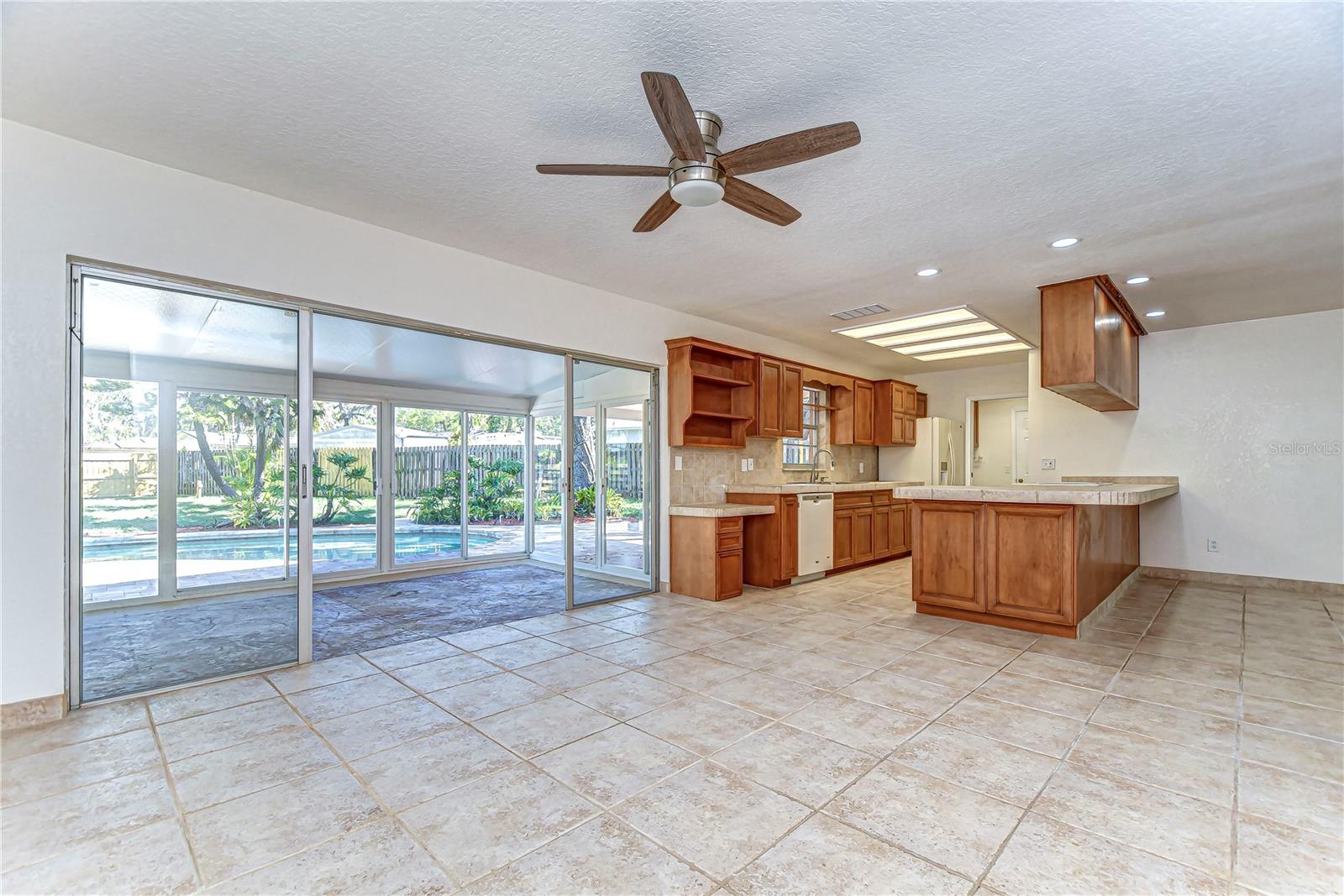 Warm wooden cabinetry provides ample storage, while the large sliding doors bring the outdoors in, creating an entertainer's paradise in the heart of your home.