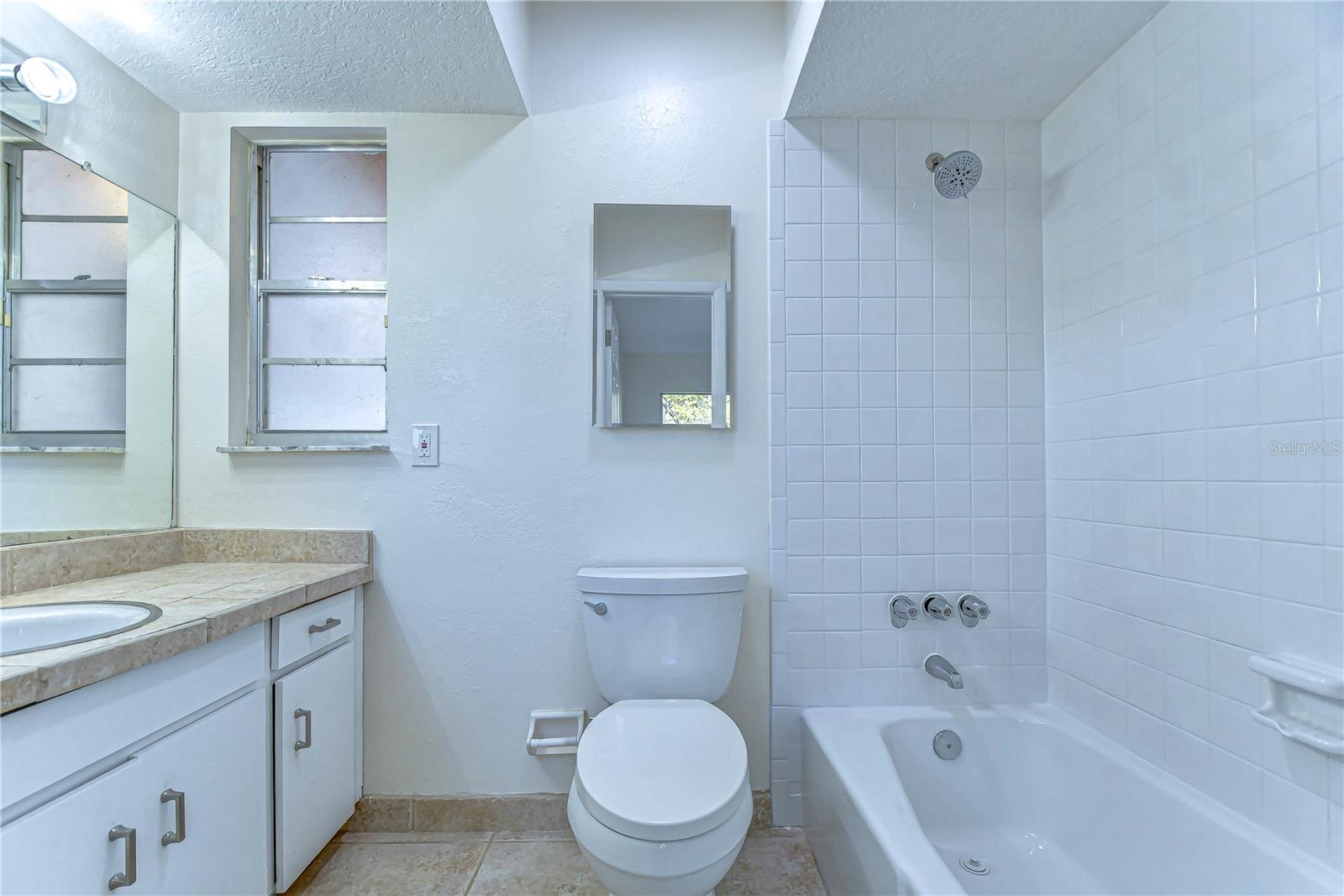 Step into this elegant bathroom, where modern simplicity meets functionality.