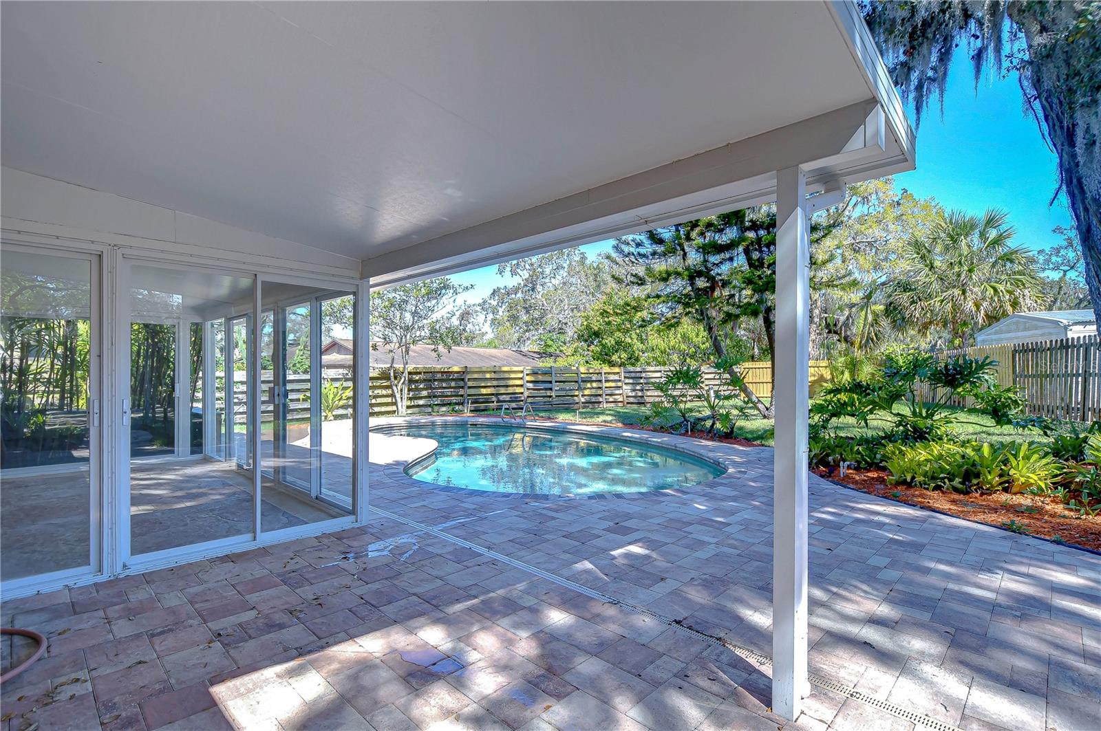 Discover your private oasis in this serene backyard retreat, featuring a sparkling pool and covered patio perfect for entertaining or unwinding.