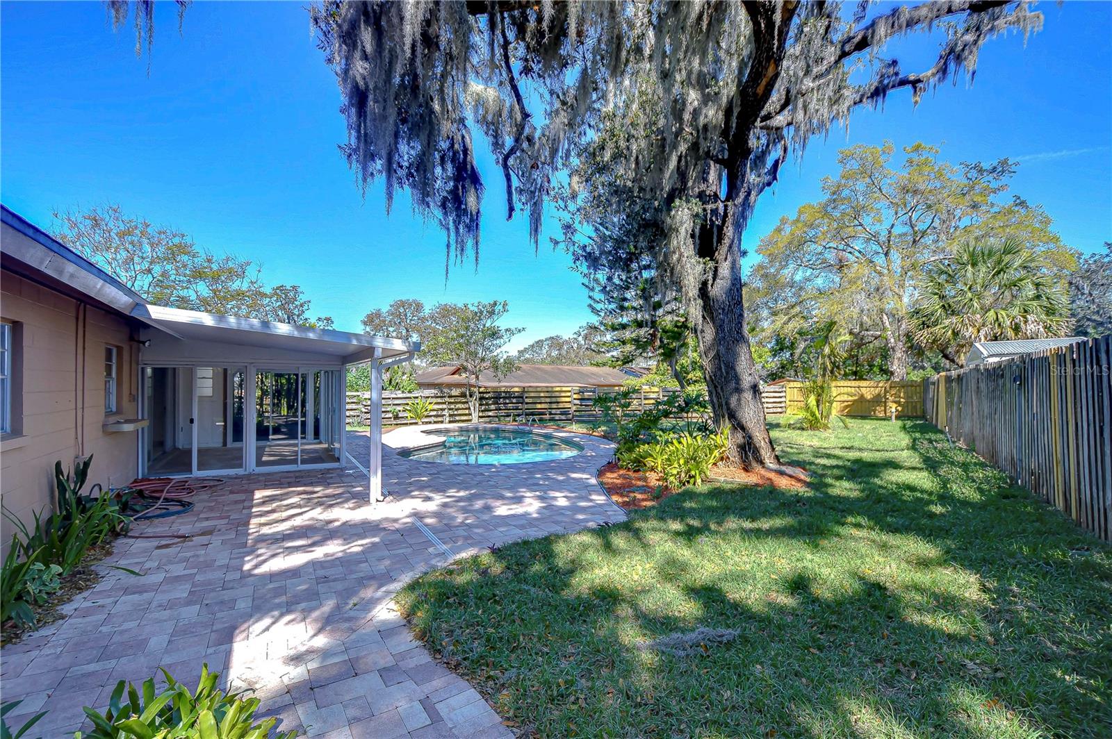 The meticulously paved pool area promises leisurely weekends and refreshing dips, all tucked away in a peaceful, verdant oasis.