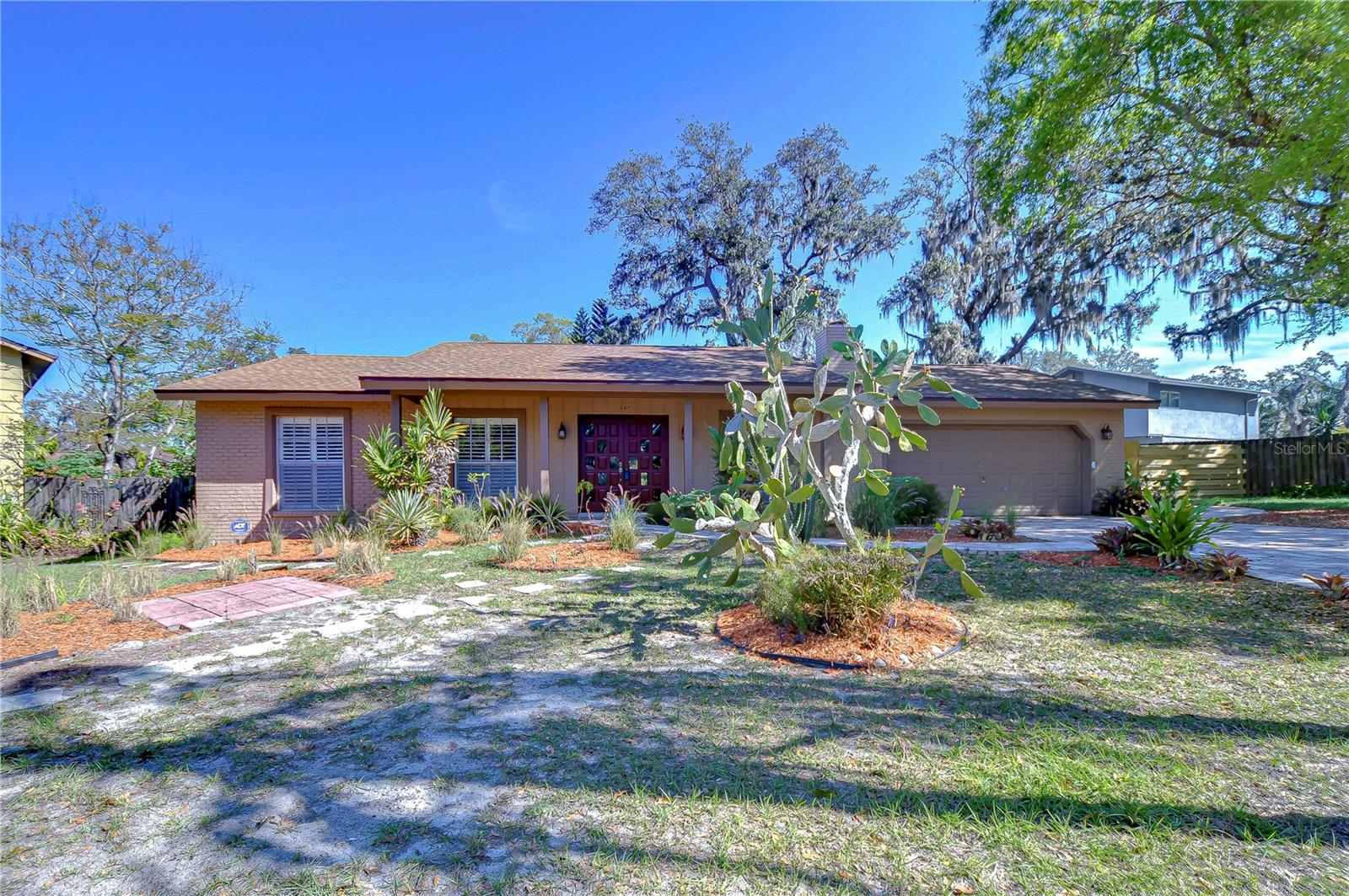 Nestled amidst mature trees, this charming three-bedroom, two-bath residence offers a perfect blend of comfort and style.