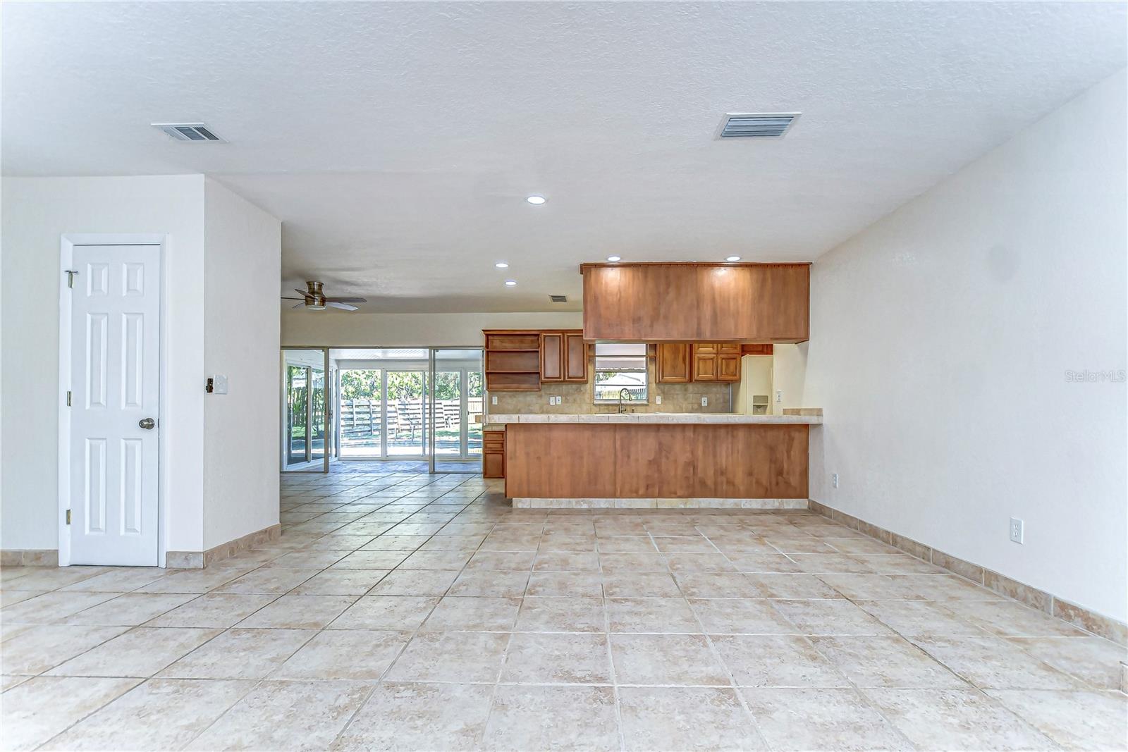 he ample natural light pours through sliding glass doors, leading to a relaxed outdoor space