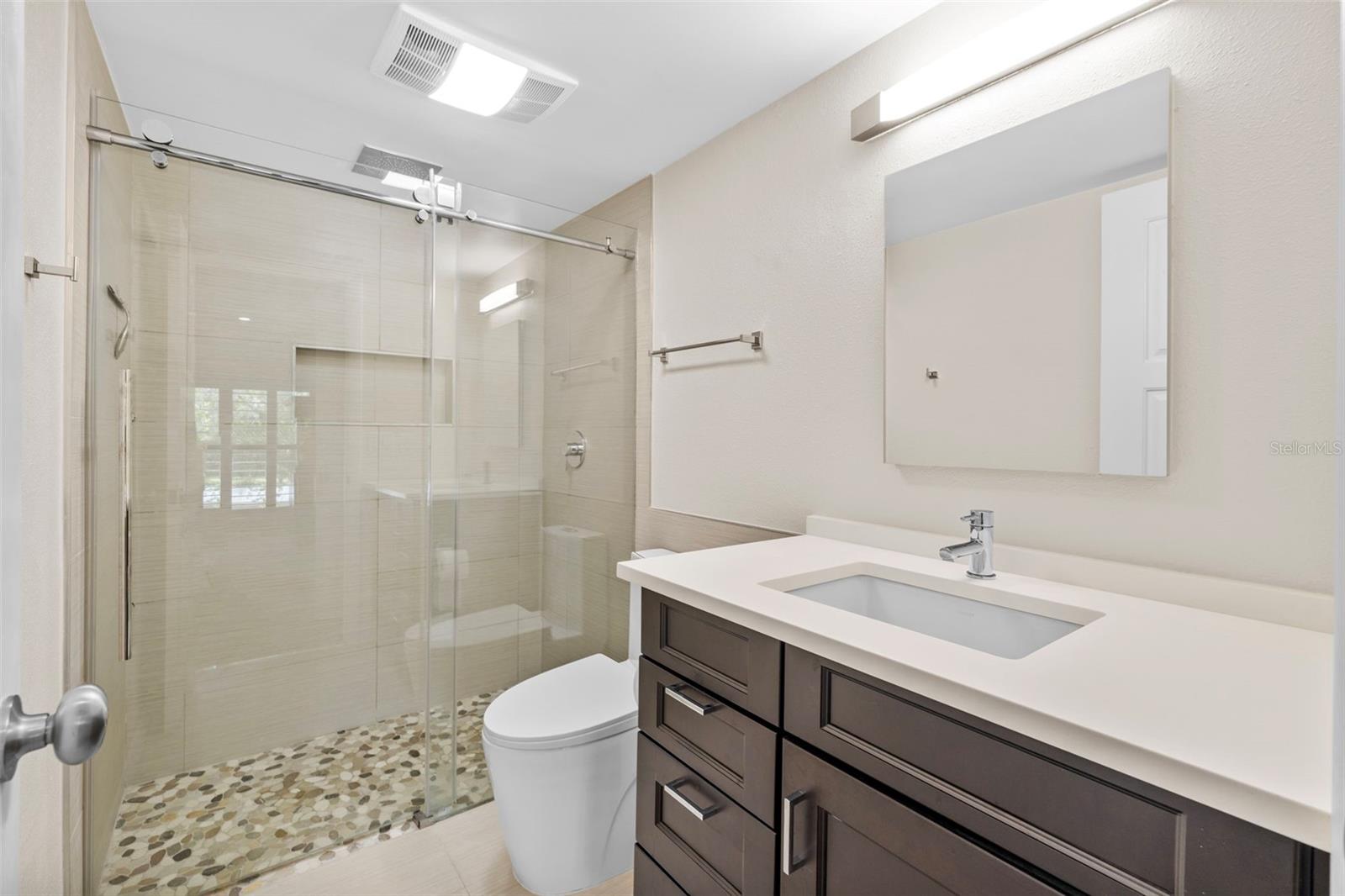 Primary bathroom lavatory and shower stall