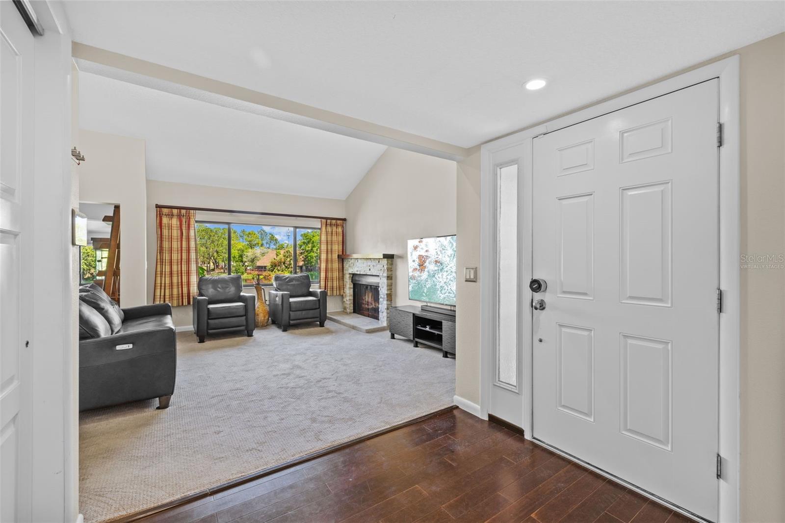 Entryway to living room view. (fireplace flame is virtually staged)