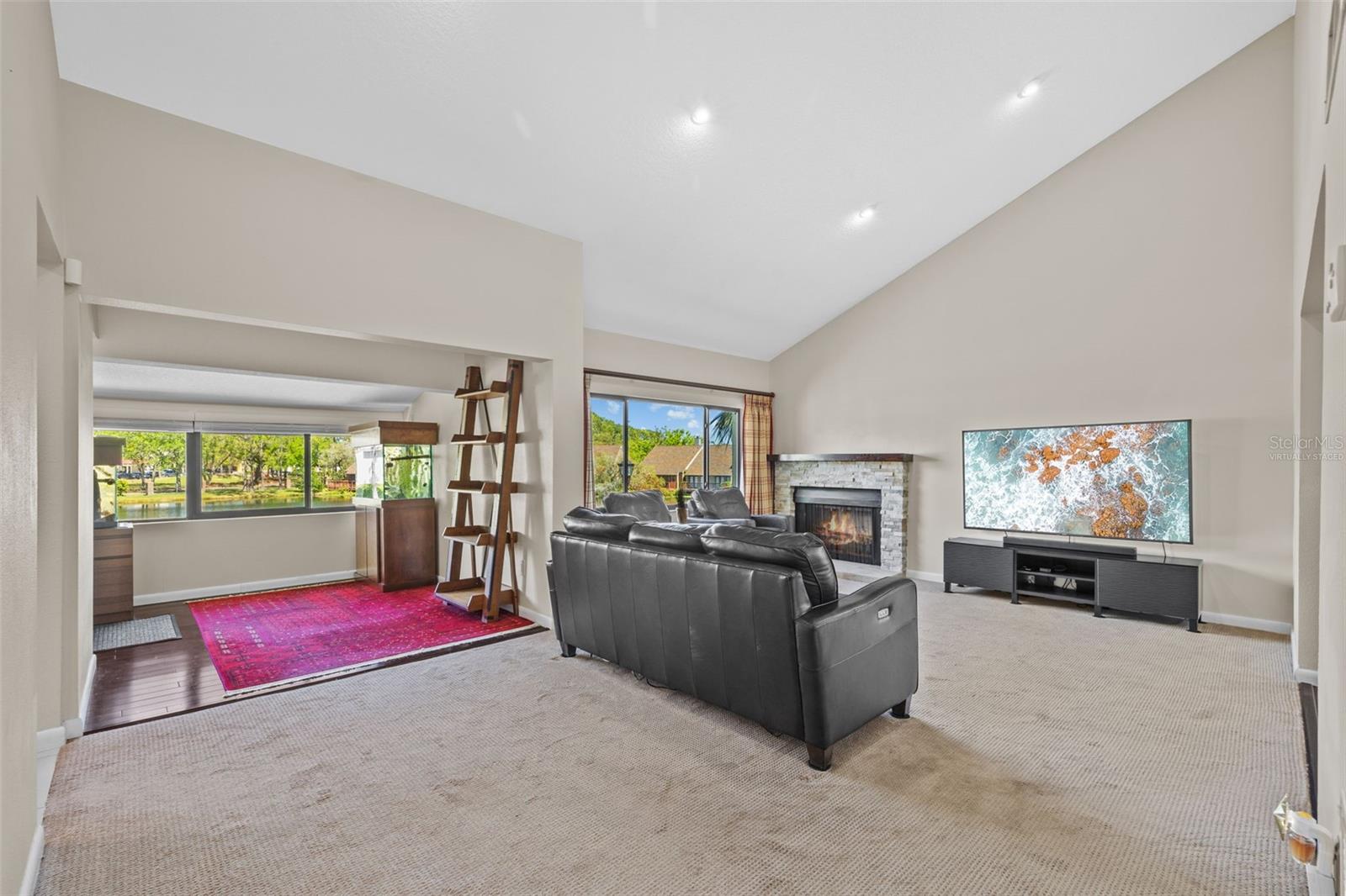 Living room view to bonus area (fireplace flame is virtually staged)