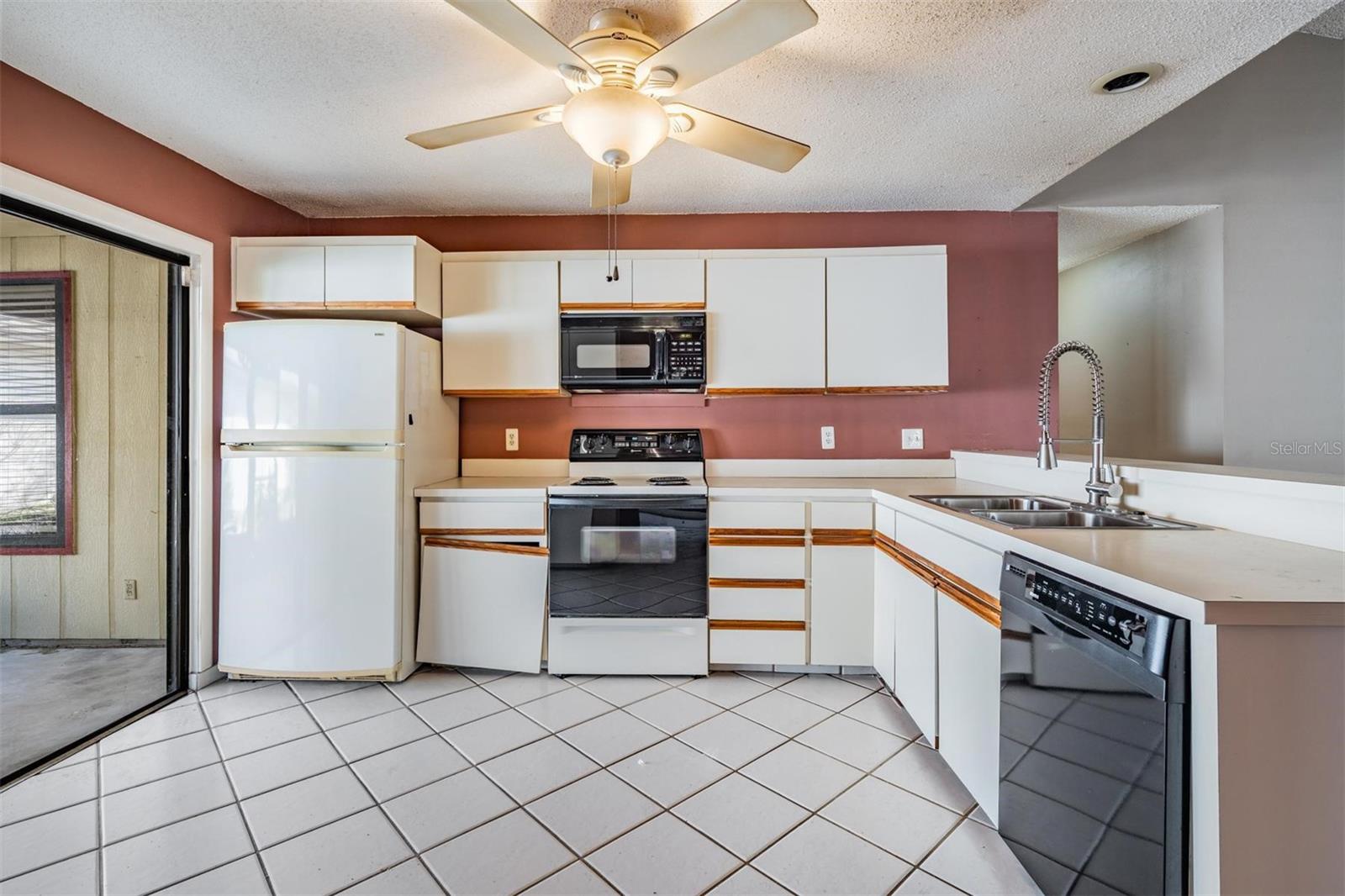 Kitchen opens to screened patio and overlooks family room.