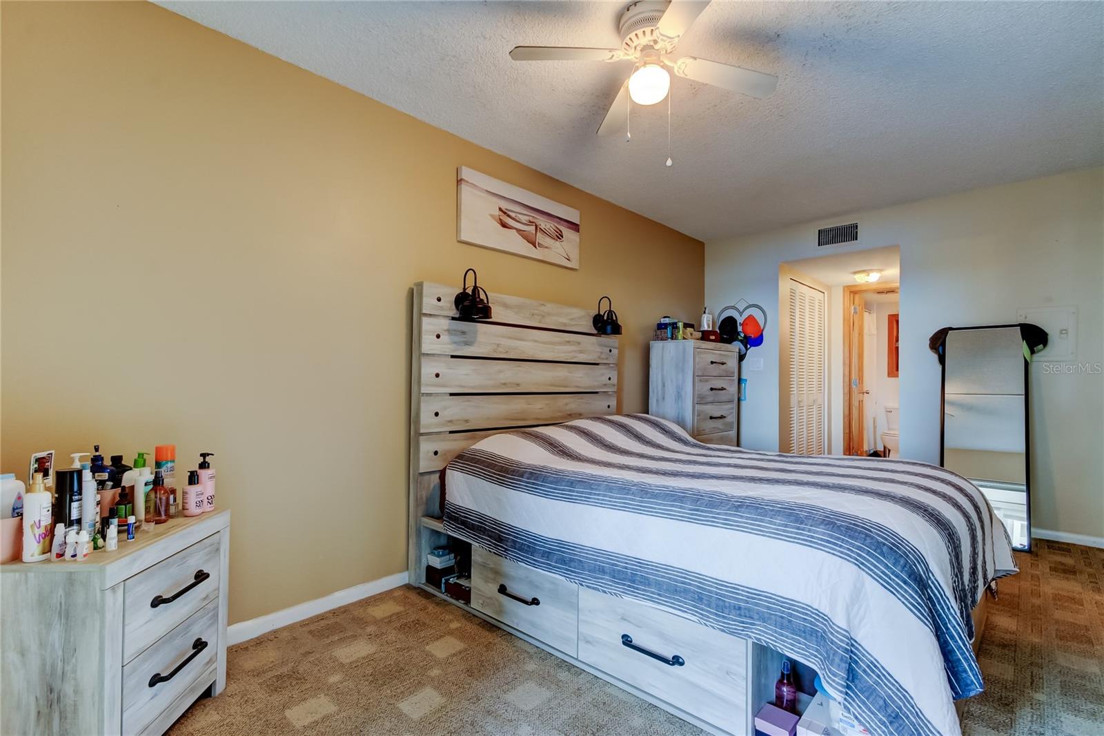 Bedroom with view into closet area and bathroom