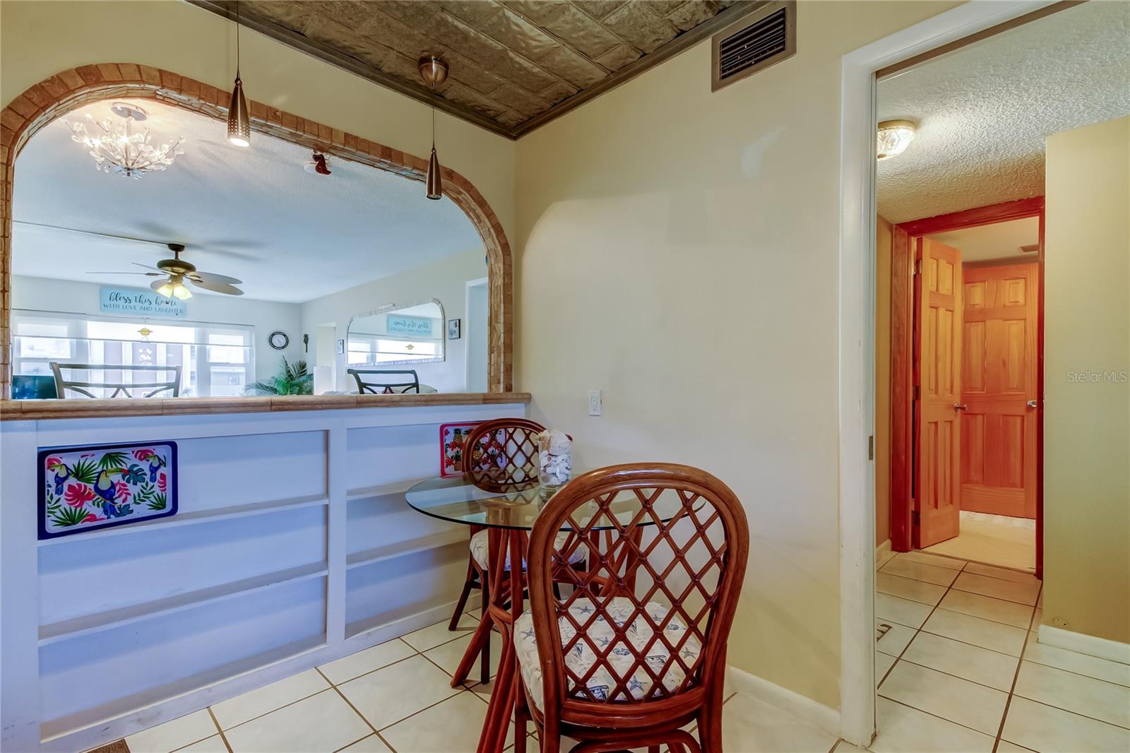 View from the Kitchen showing Living Room through the Pass Through and Bathroom Door to the Right