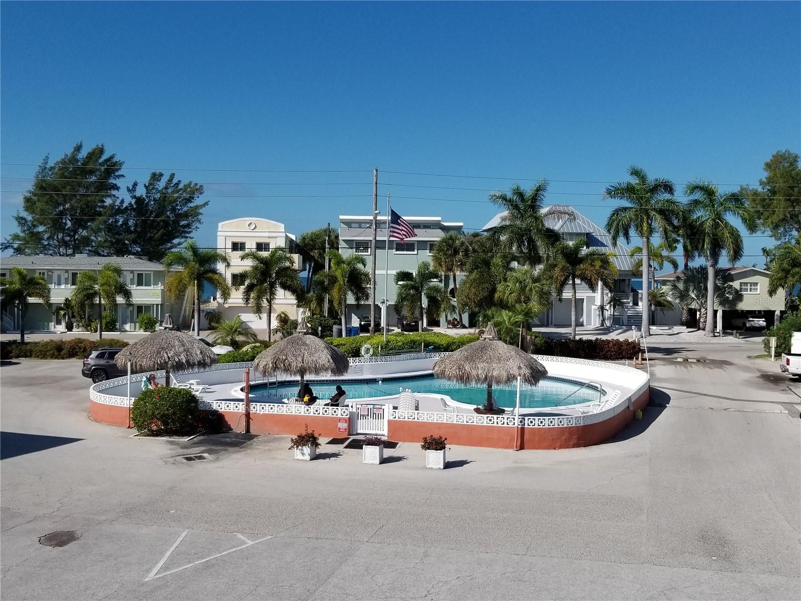 View to the pool and beach access from the condo balcony