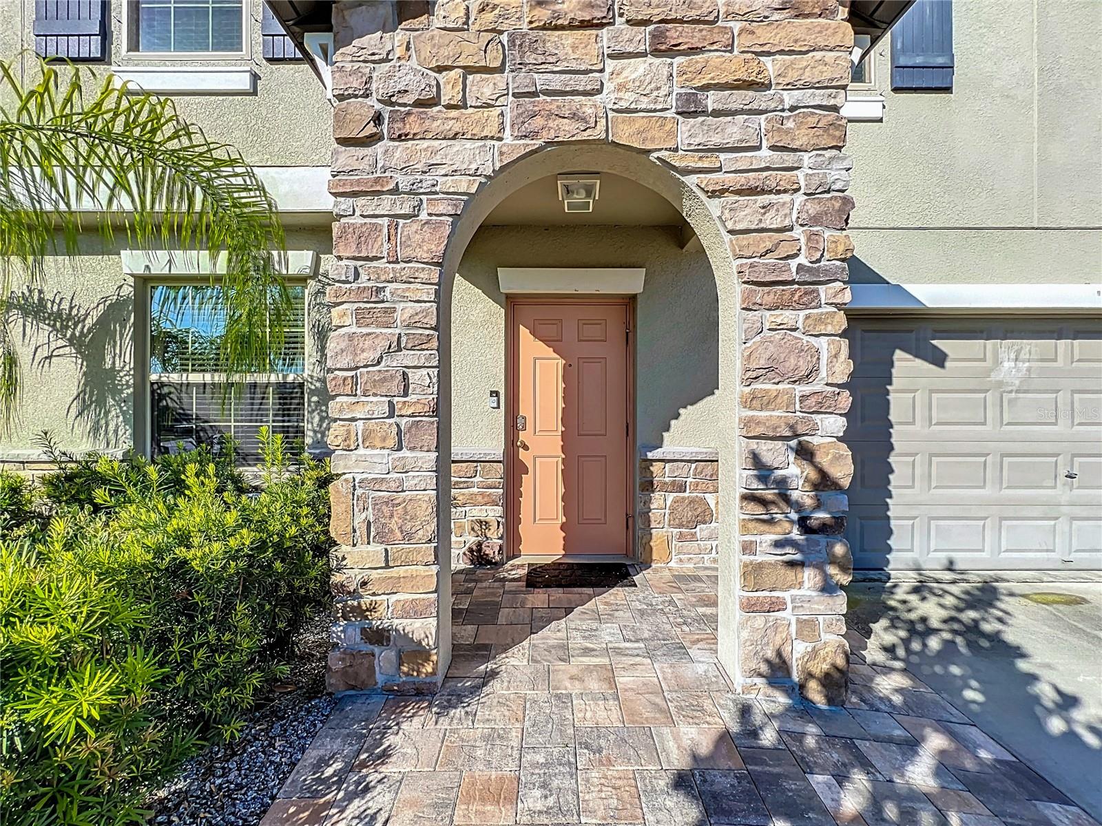 ADDED UPGRADE: EXTERIOR STACKED STONE AND EXNTED PAVER WALK WAY