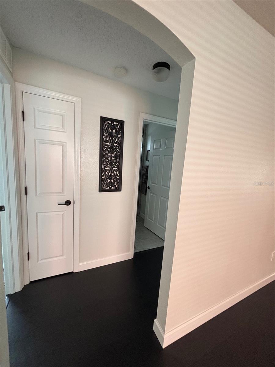 Hall to bedrooms with storage closet