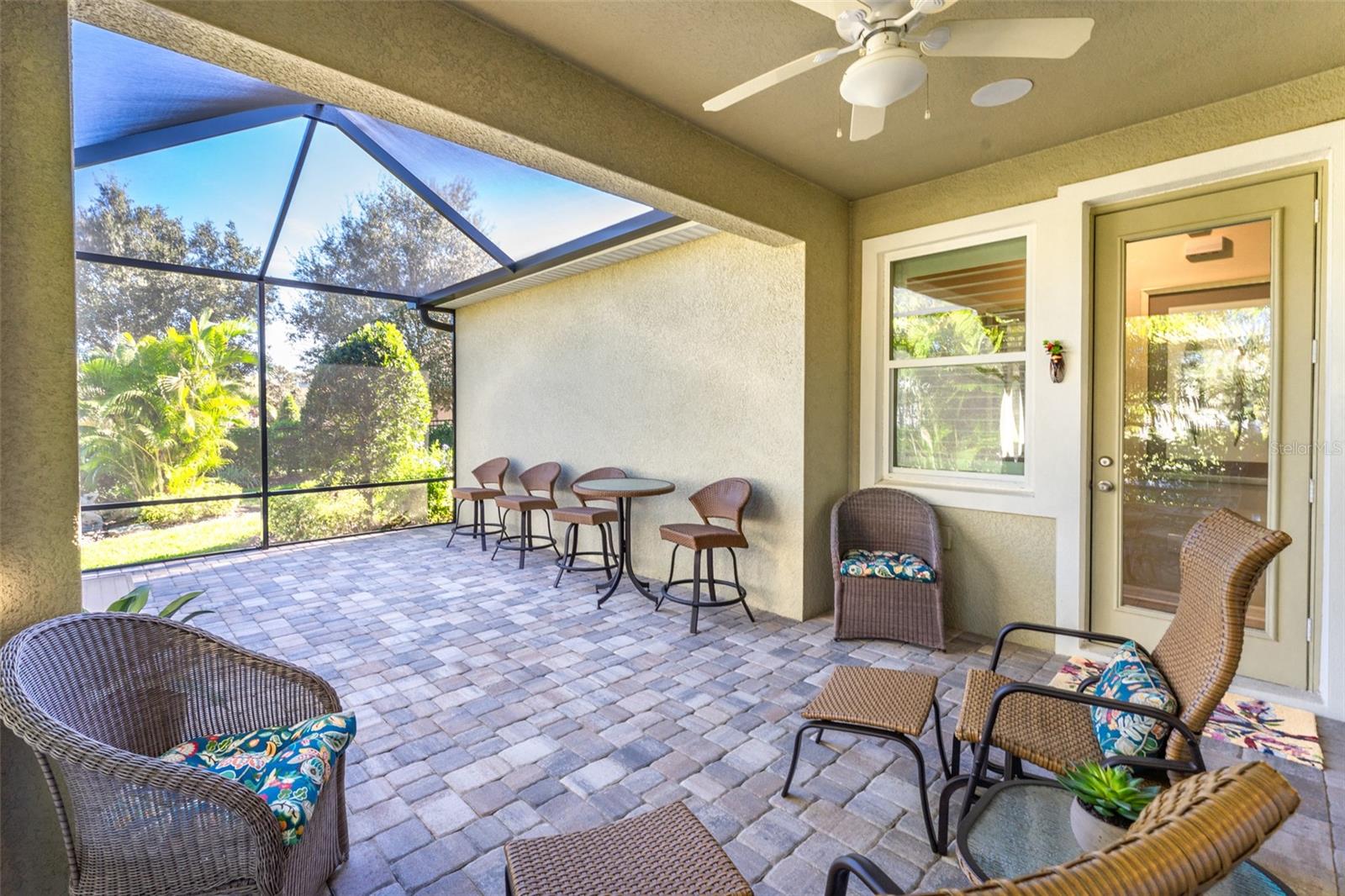 Screen Enclosed Extended Outdoor Space with Pavered Flooring