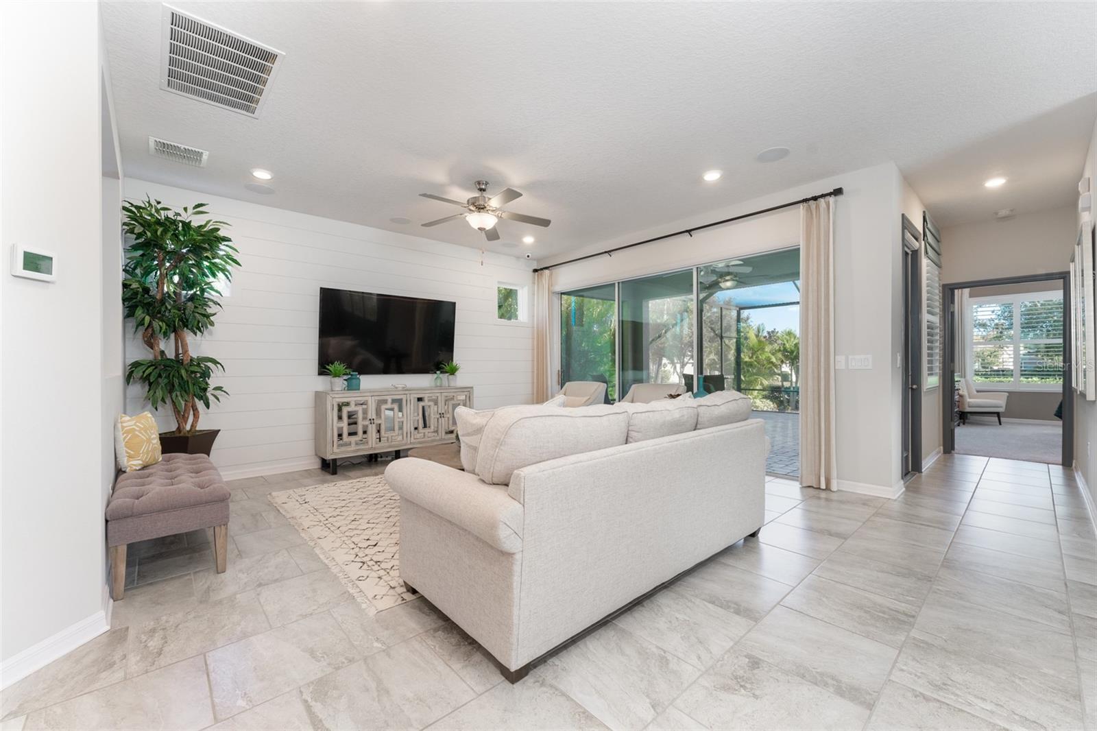 Family Room with Wood Accent Wall & Sliders to Outdoor Living Area