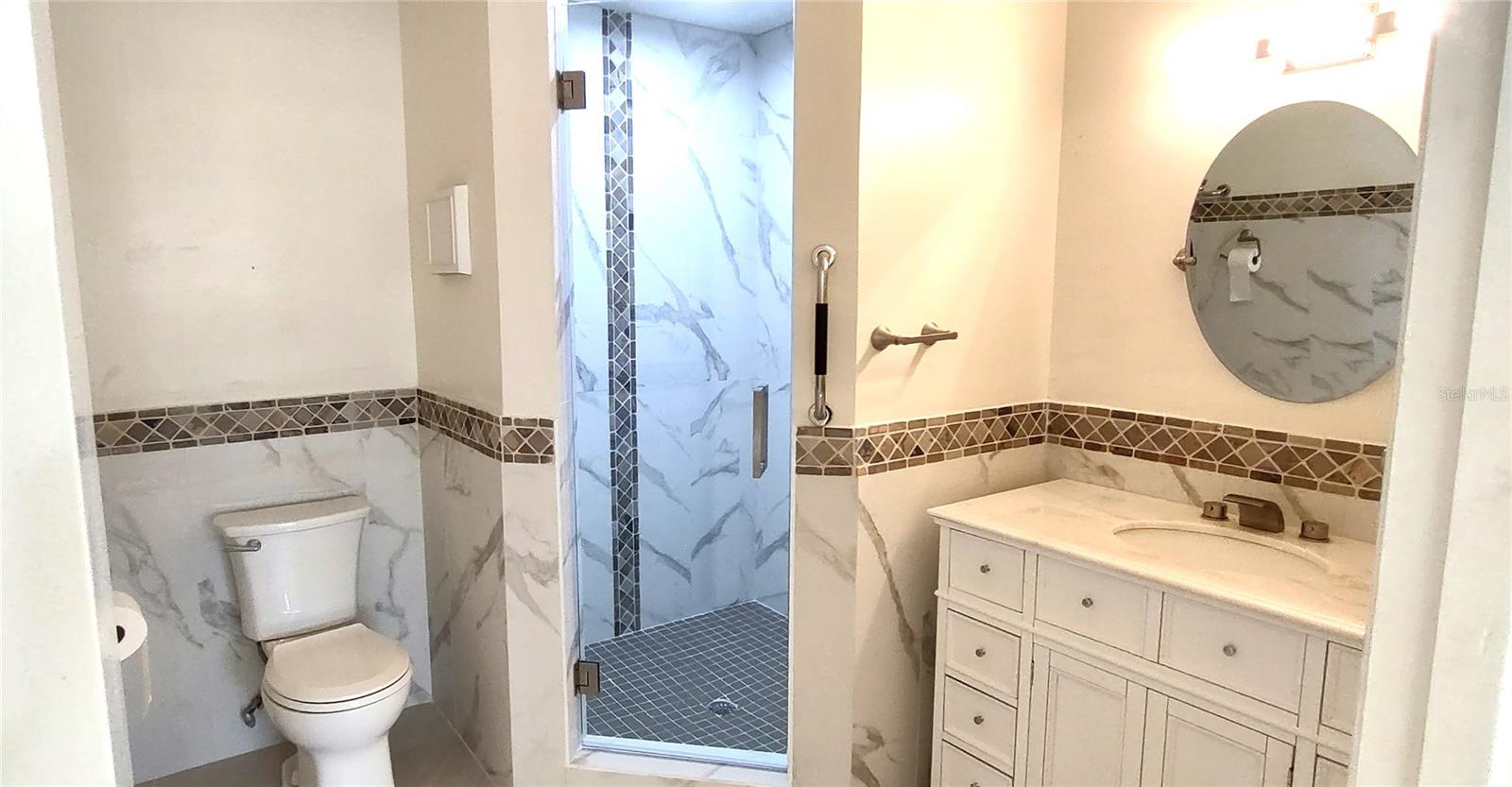 Oversized primary bath and custom tiled shower.