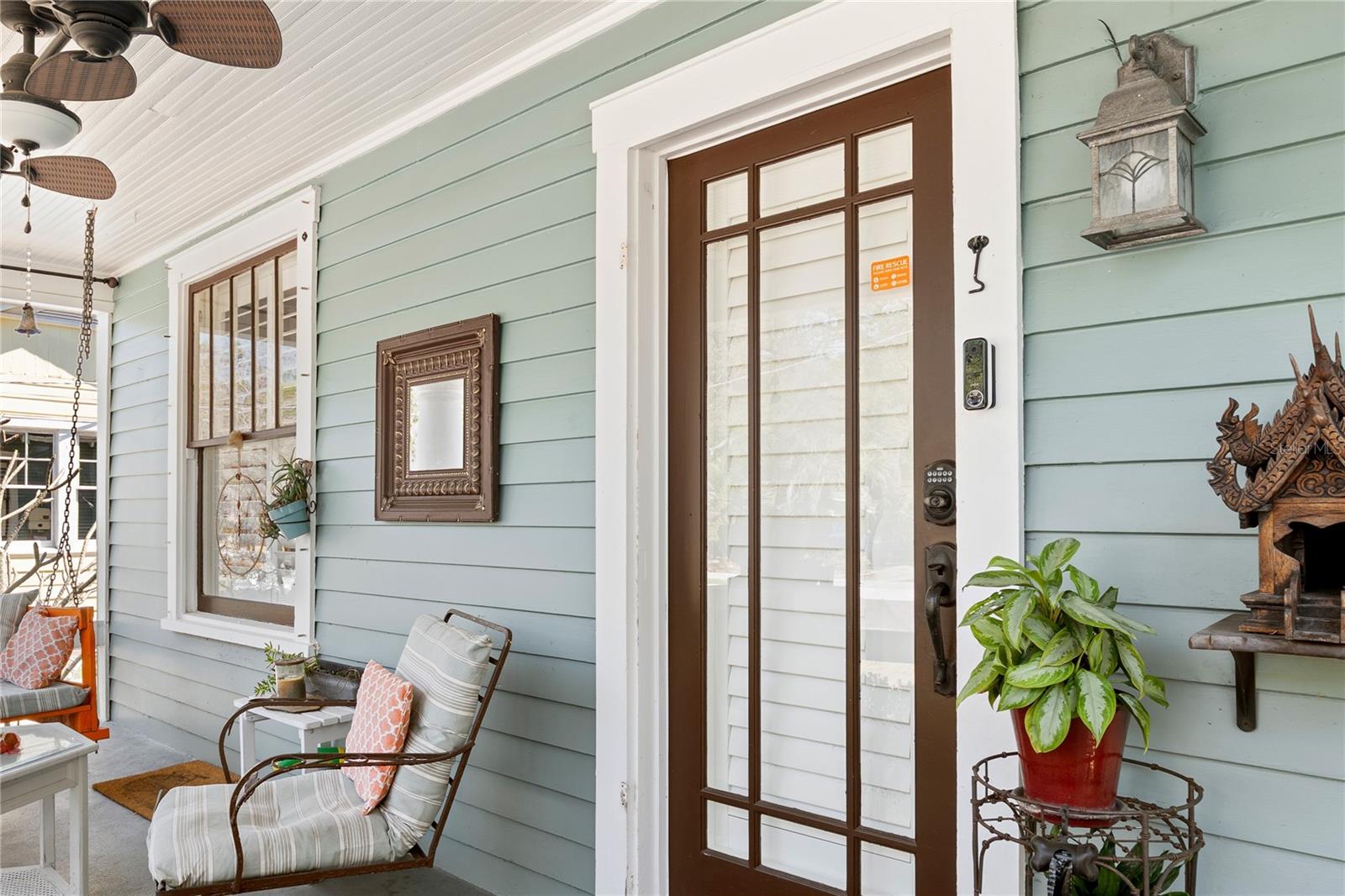 Beautiful details... ceiling fan, vintage-style entry door, and wooden detailed ceiling