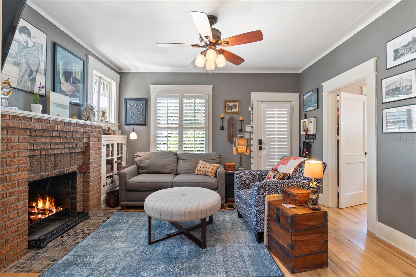 Original built-in cabinetry flanks the working fireplace