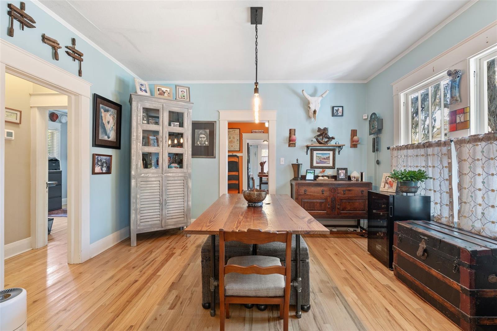 Spacious dining room with vintage windows and wood trim.