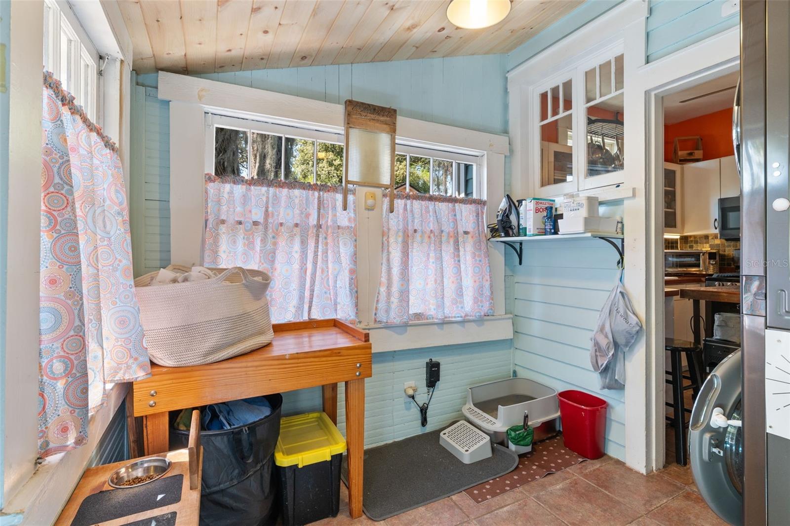 Lovely wood ceiling and original windows in the laundry/mudroom