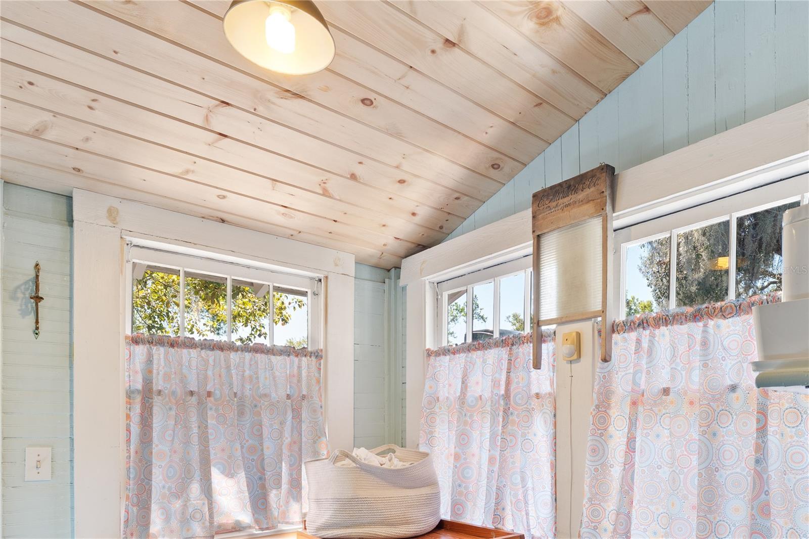 Lovely wood ceiling and original windows in the laundry/mudroom