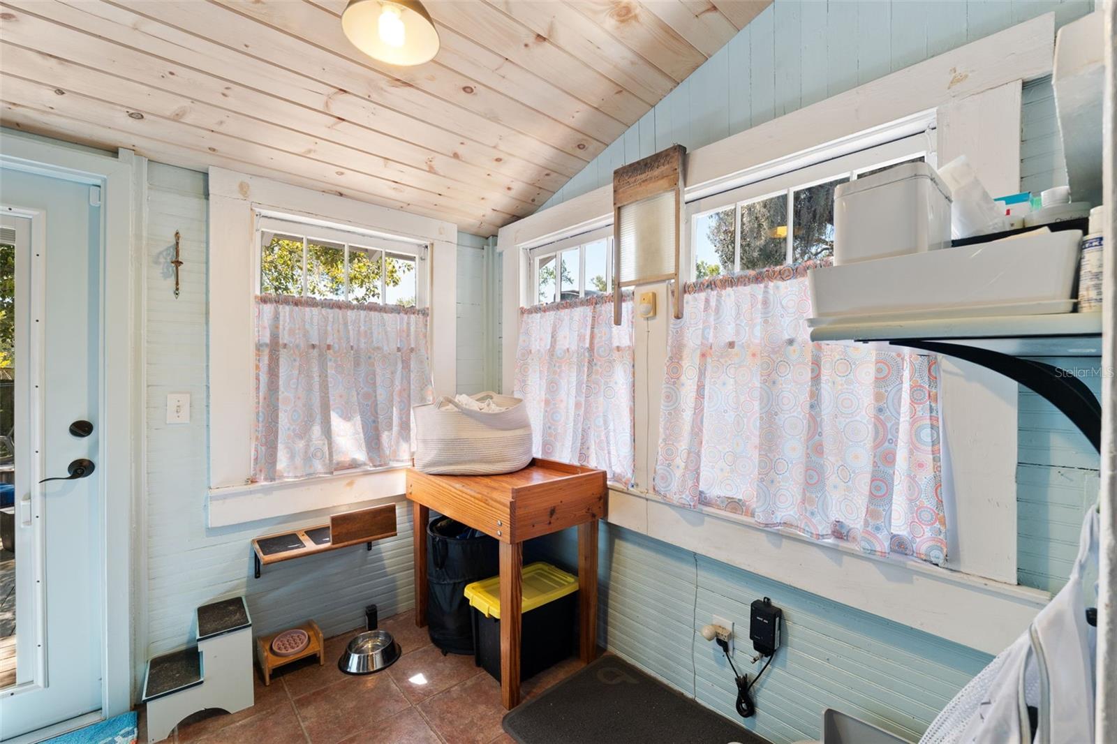 Lovely wood ceiling and original windows in the laundry/mudroom