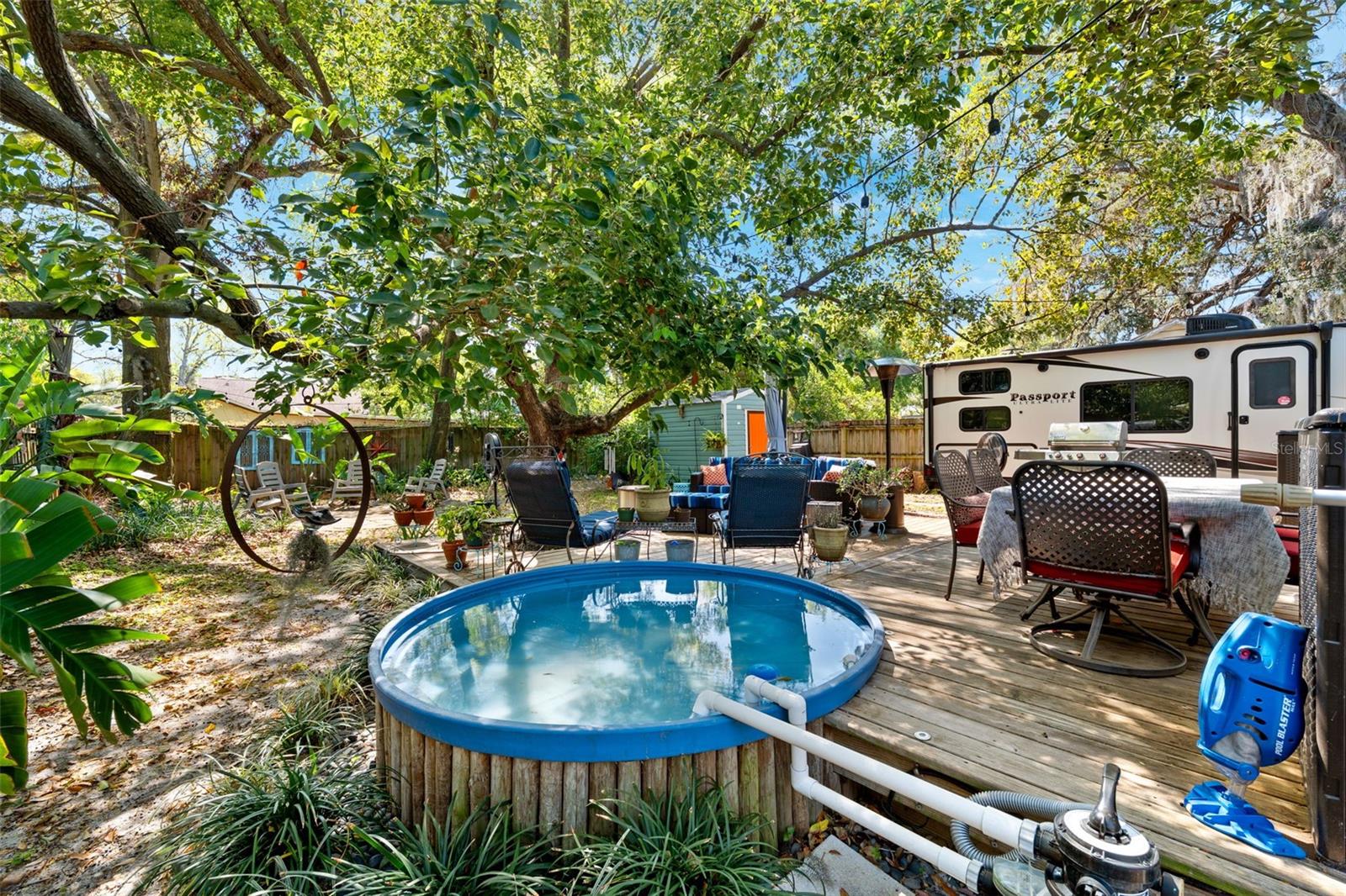 Stock tank pool and custom deck. poised at the top of the expansive rear garden