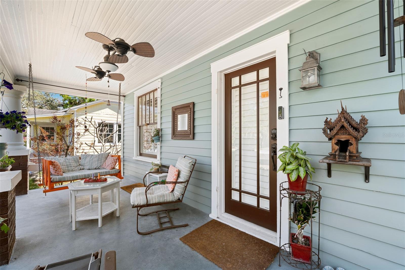 Beautiful details... ceiling fan, vintage-style entry door, and wooden detailed ceiling