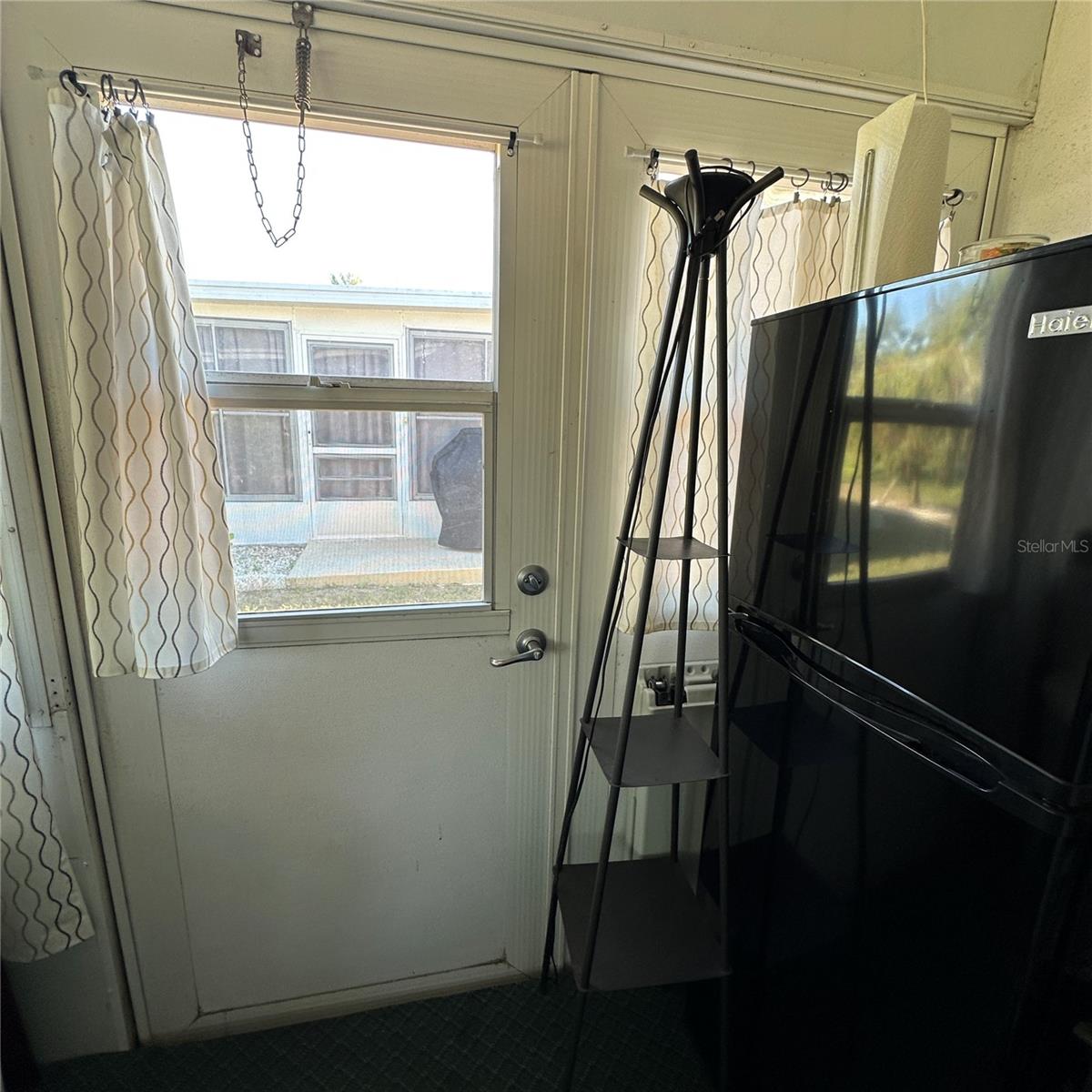 Double doors on the lanai from access to store golf cart.