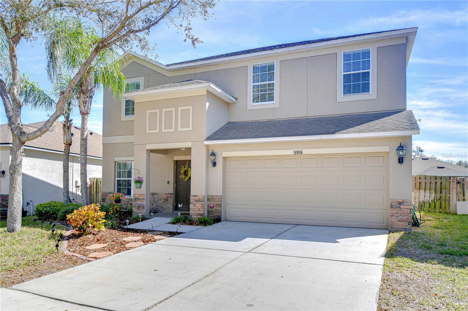 This charming two-story residence offers a serene suburban retreat complete with a spacious driveway and meticulously landscaped front yard.