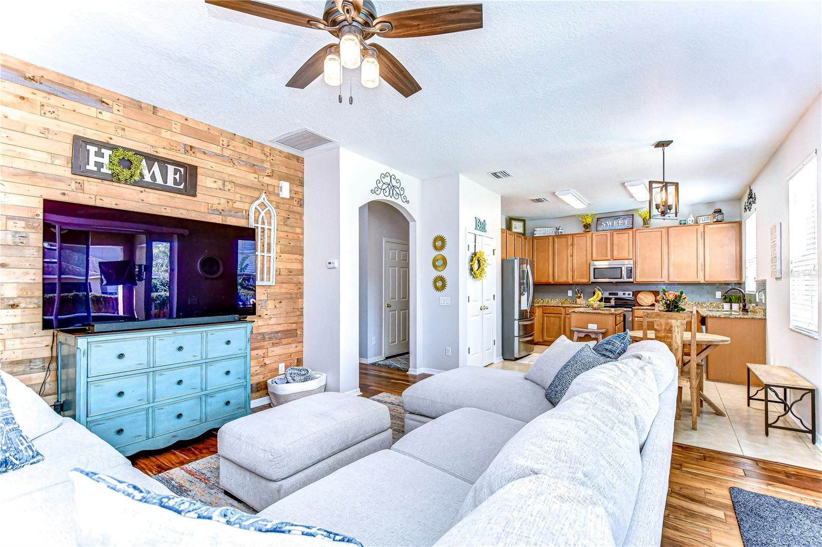 The open-concept living room seamlessly flows into a stylish kitchen, perfect for entertaining.