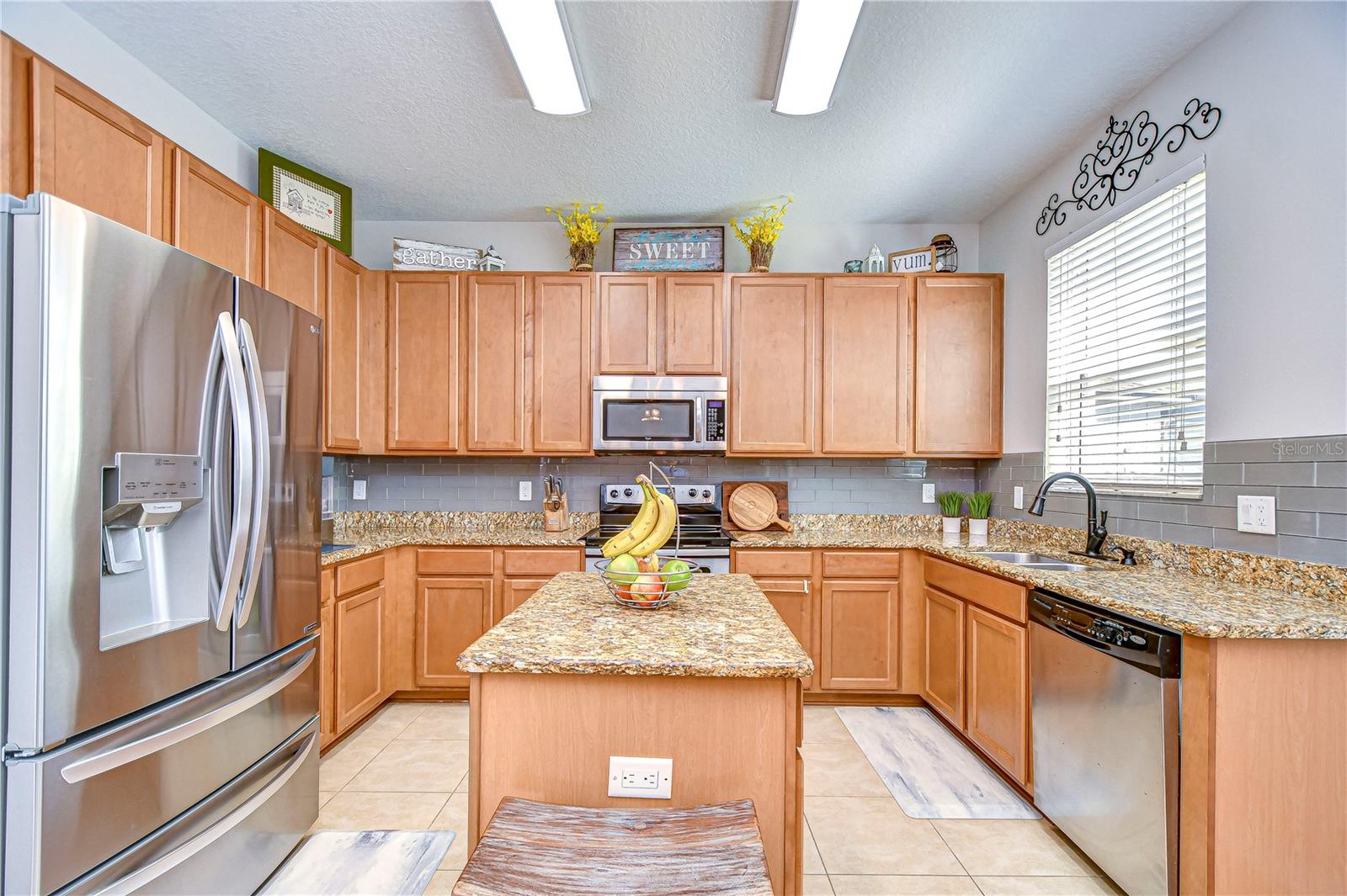 This kitchen boasts exquisite granite countertops and a charming island for both functionality and style.