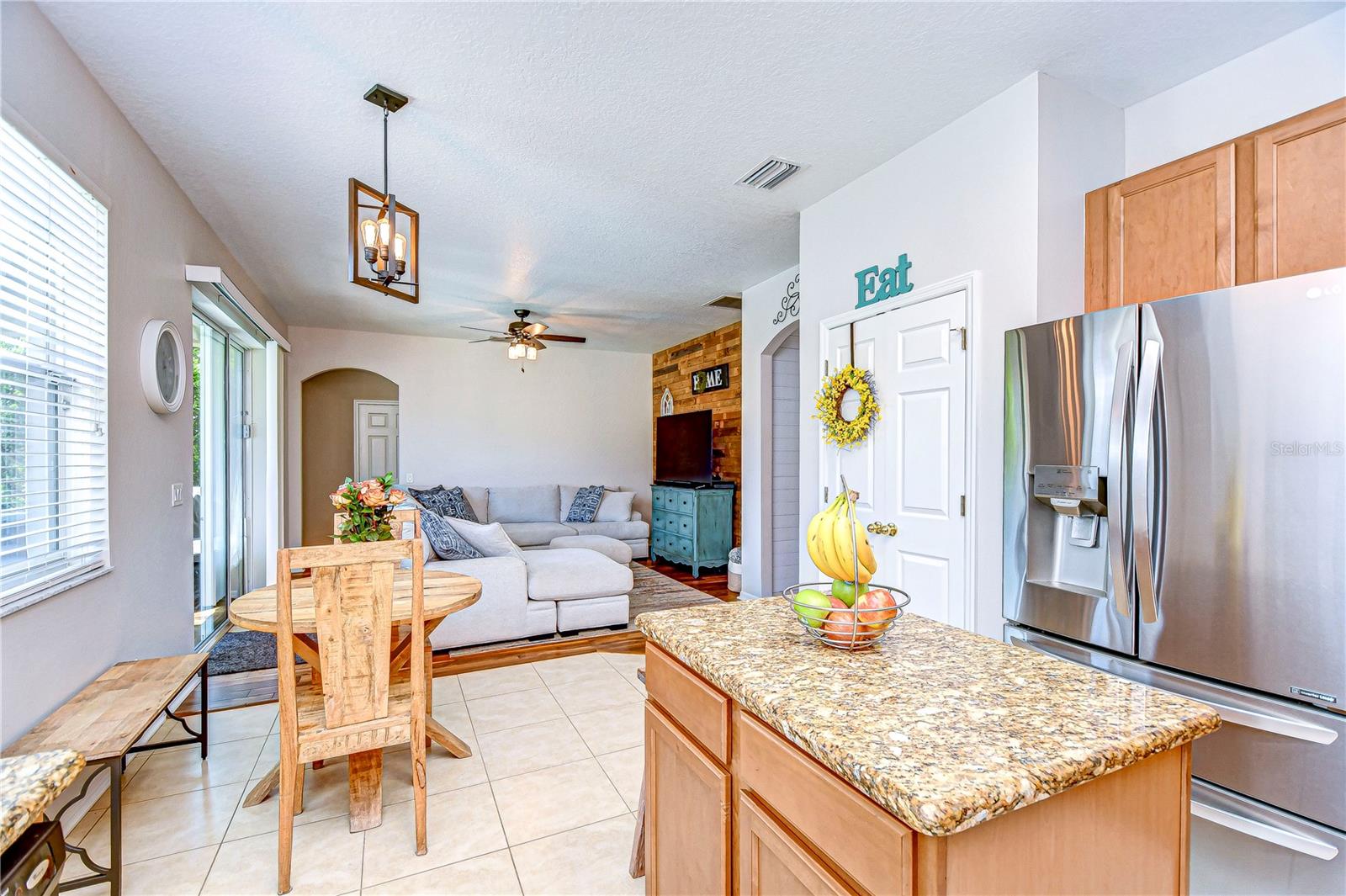 he kitchen boasts a gleaming granite island, ideal for both prep work and casual dining