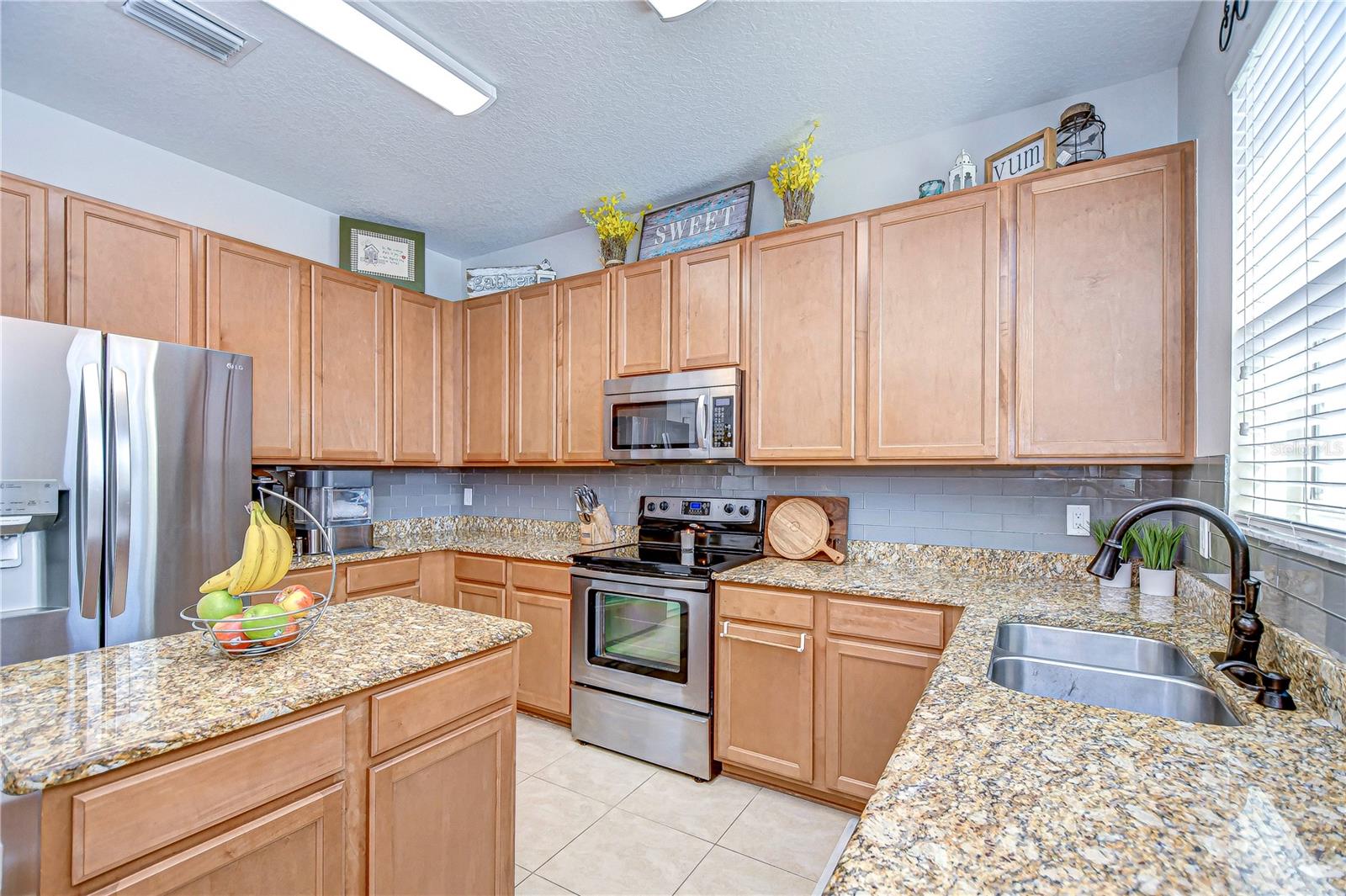 The stainless steel appliances, including a modern oven and refrigerator, offer both style and functionality.