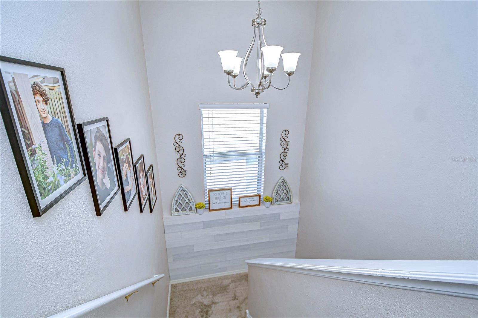 Ascend this inviting staircase, adorned with personal touches and bathed in natural light.