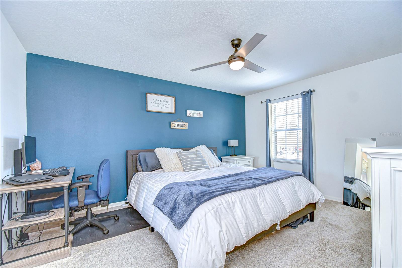 Step into the serene primary bedroom, where comfort meets style