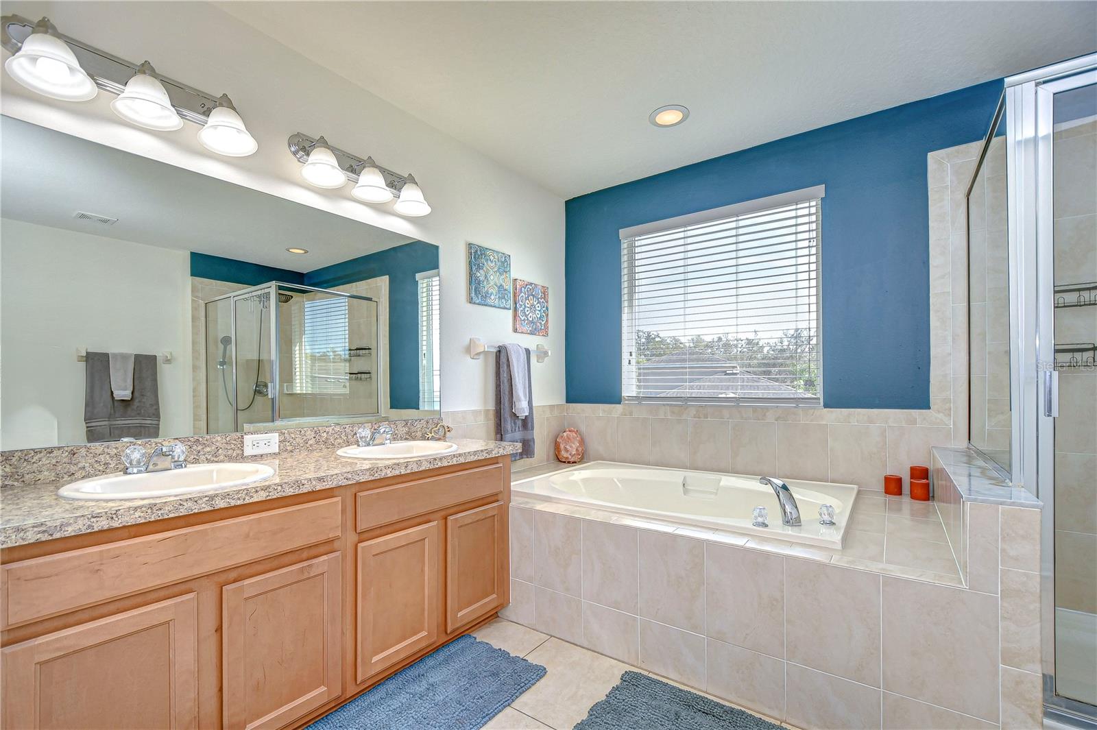 This bathroom boasts both a luxurious tub and a sleek shower, perfect for unwinding after a long day.
