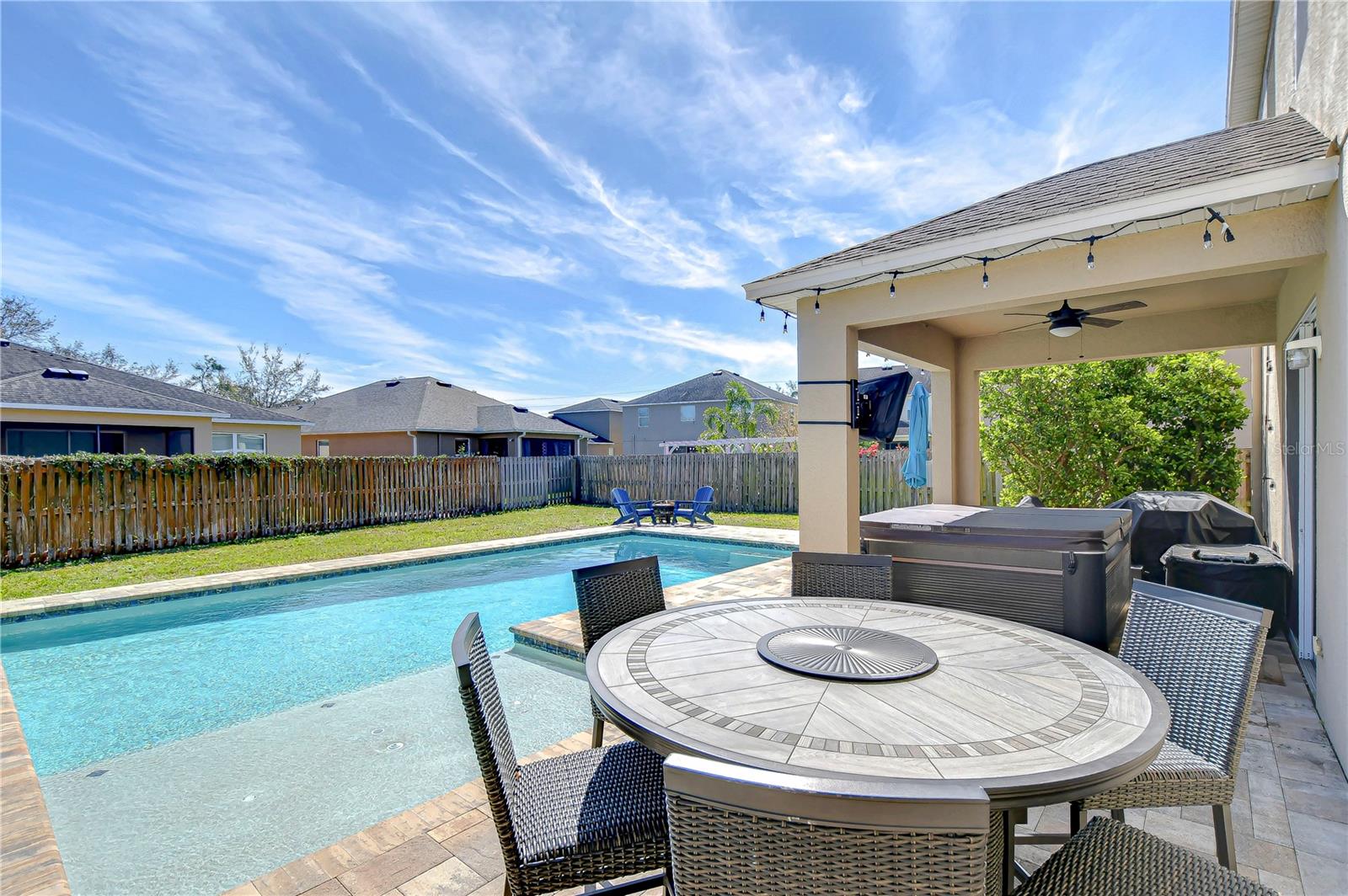 Escape to your private oasis featuring a shimmering pool and inviting covered patio, perfect for unwinding under the Florida sun.