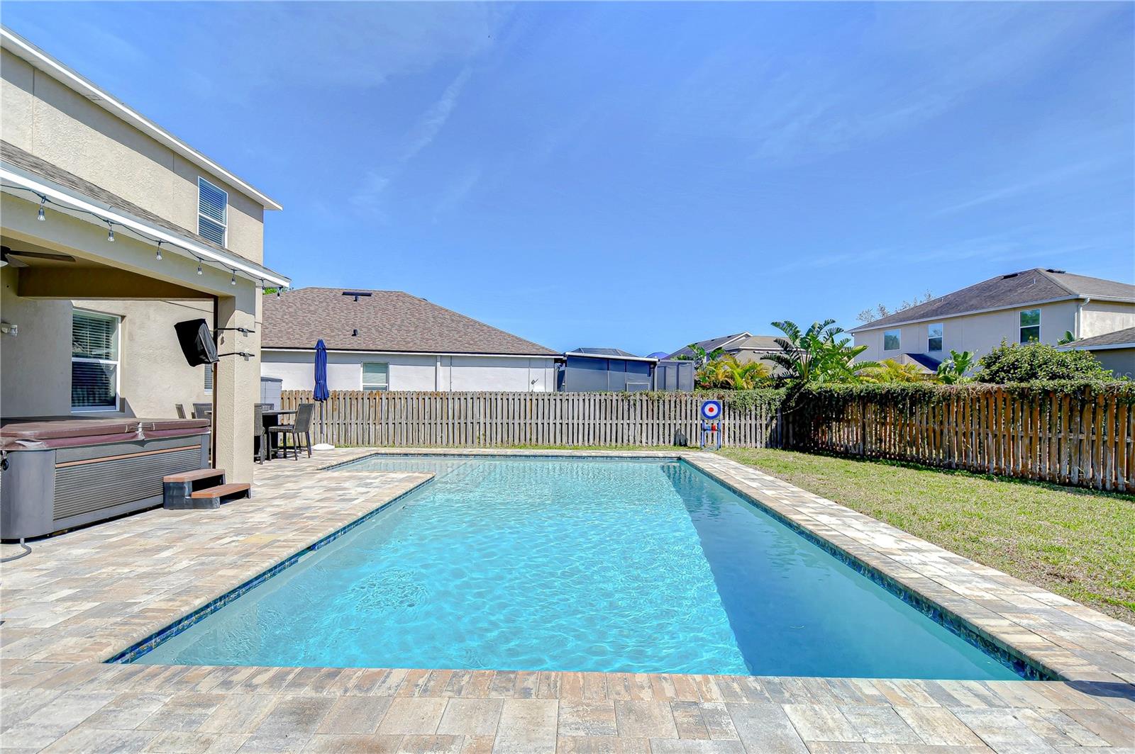 Imagine warm, sunlit days spent lounging by the water or hosting delightful gatherings on the spacious patio.