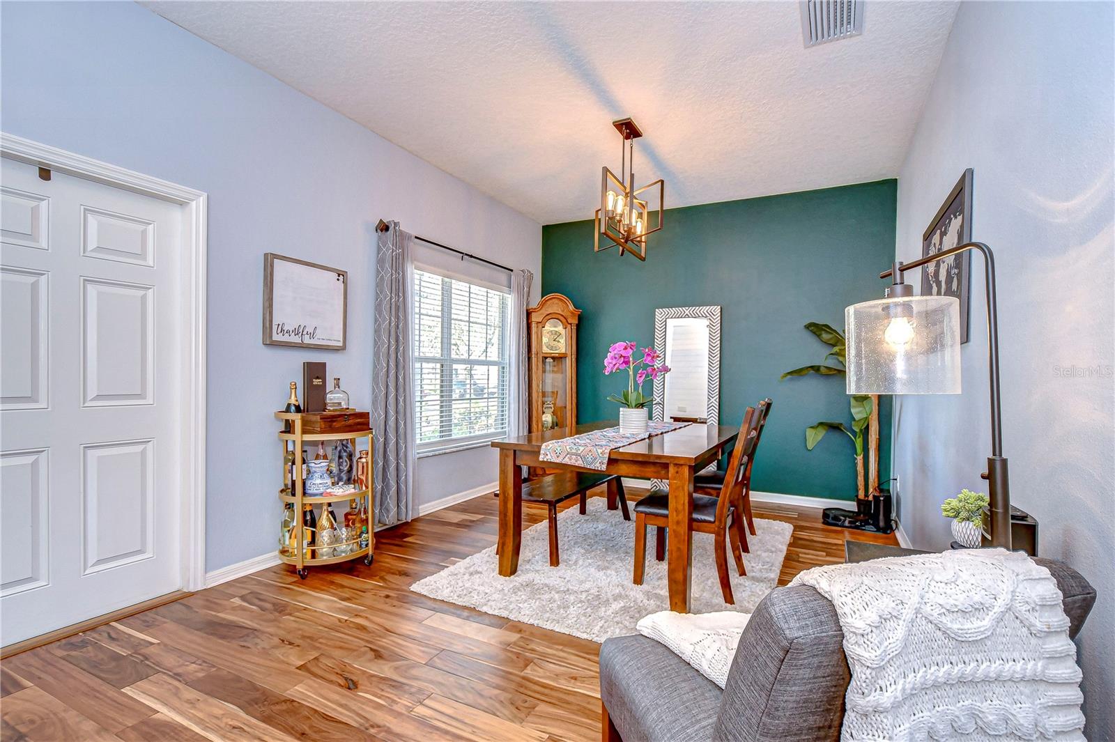 Elevate your dining experiences in this stylish room featuring elegant flooring and an abundance of natural light.