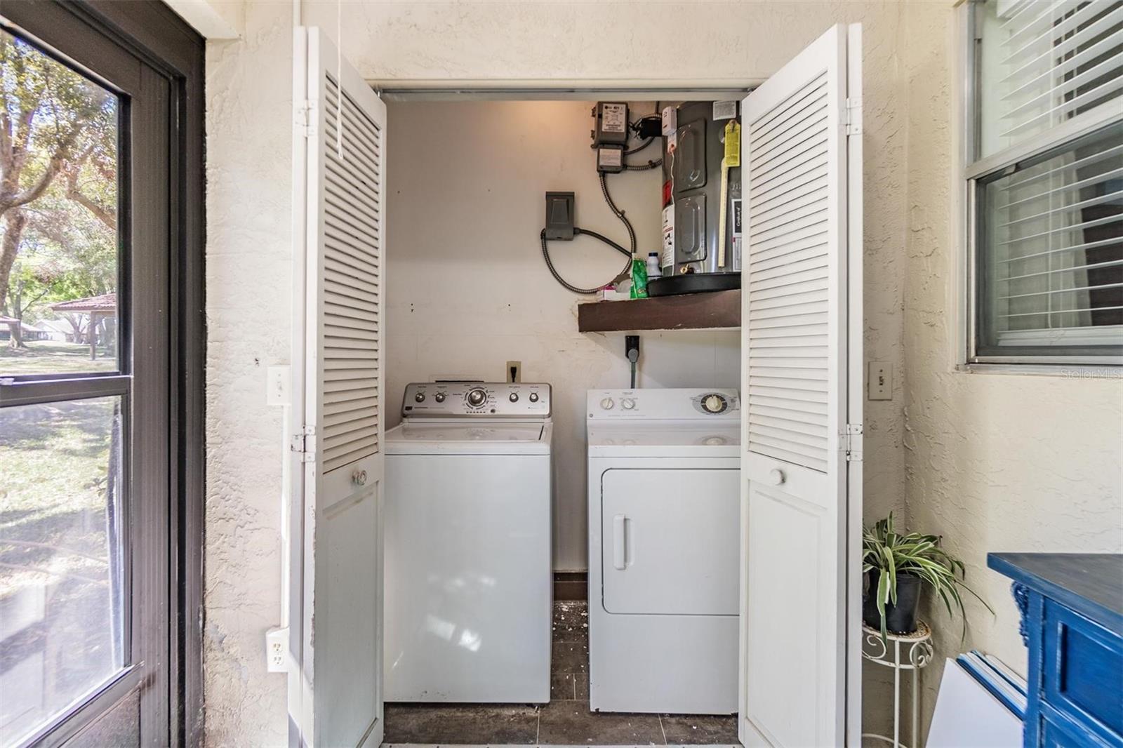 Screened-in lanai with laundry closet and access to outdoor patio.