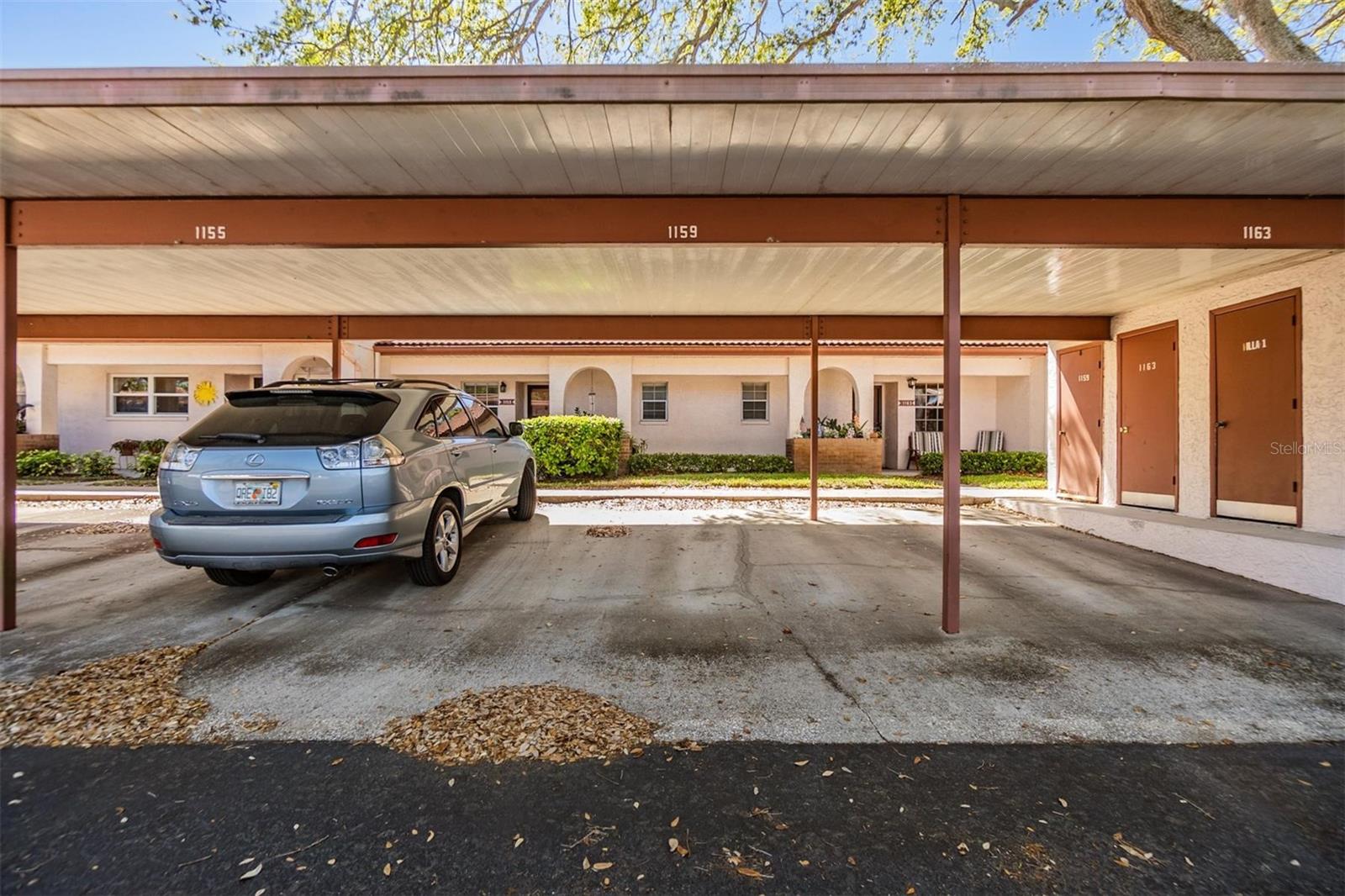 Covered parking and storage closet in front of home