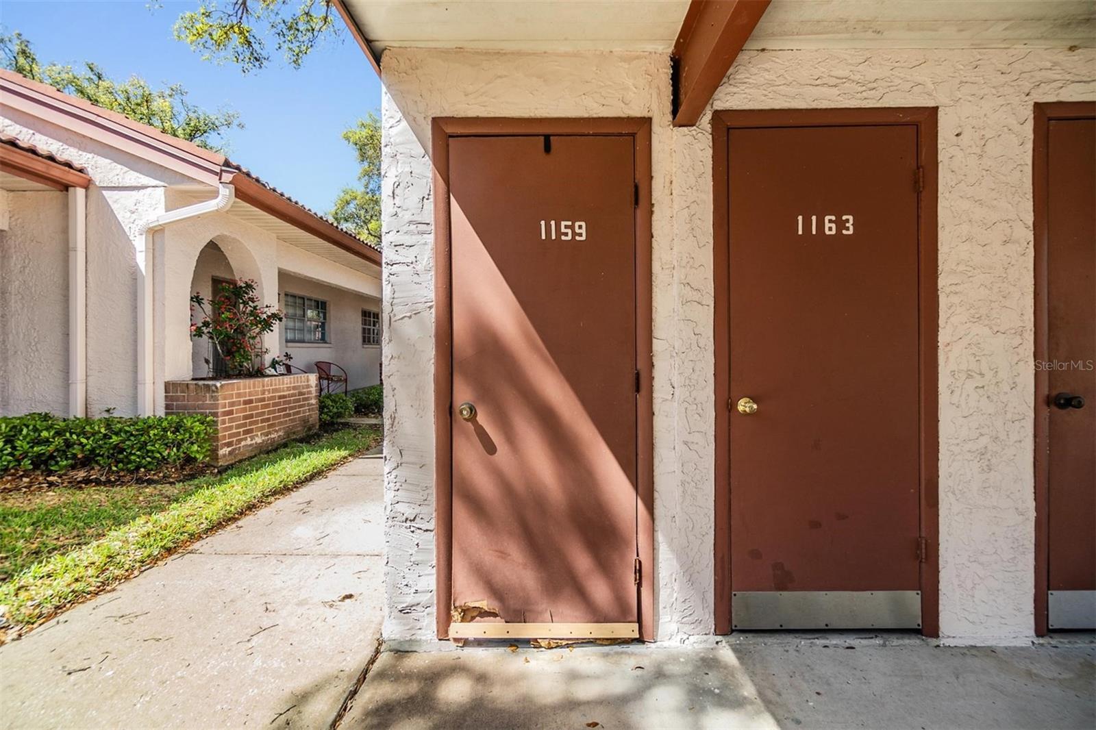 Covered parking and storage closet in front of home